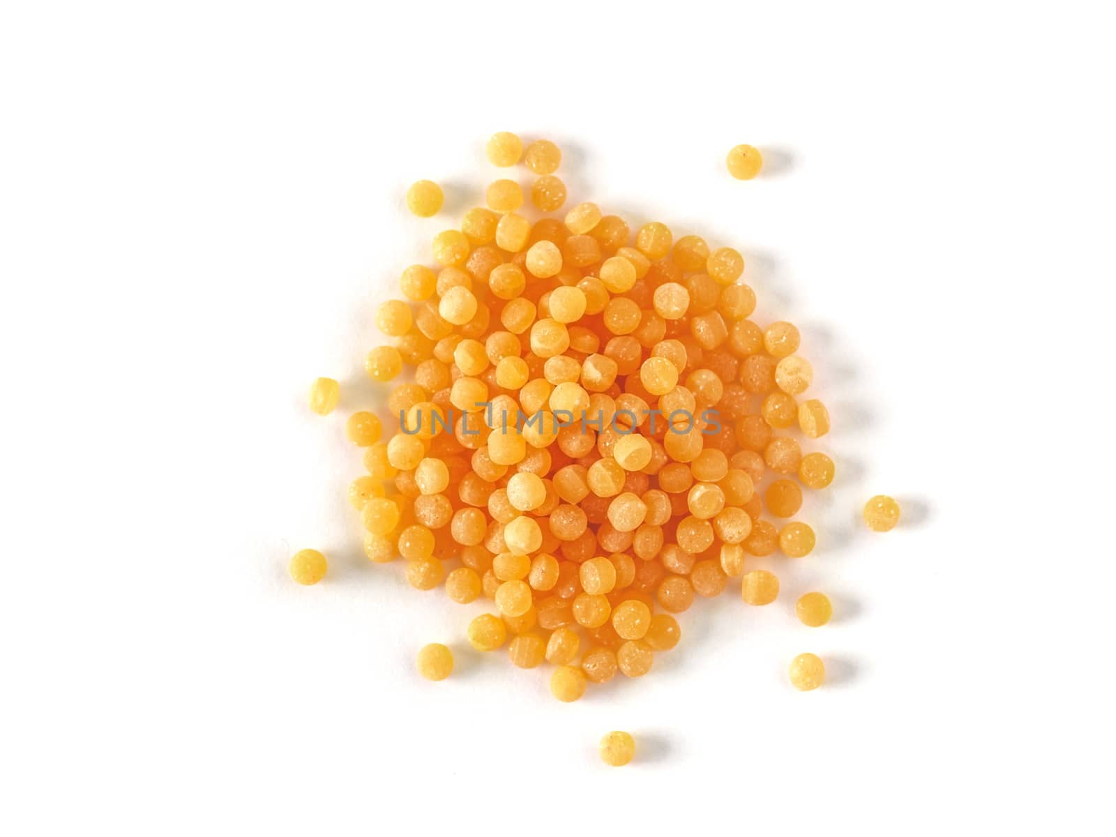 Top view of ptitim pasta isolated on white background. Ptitim or couscous is traditional israeli food. Dry or raw ptitim with copy space for text.