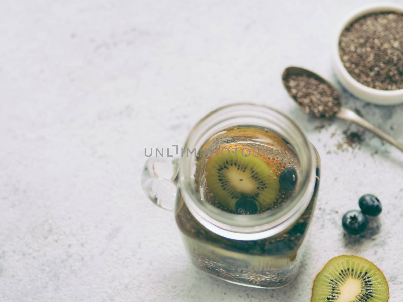 Kiwi and blueberry chia water in mason jar by fascinadora