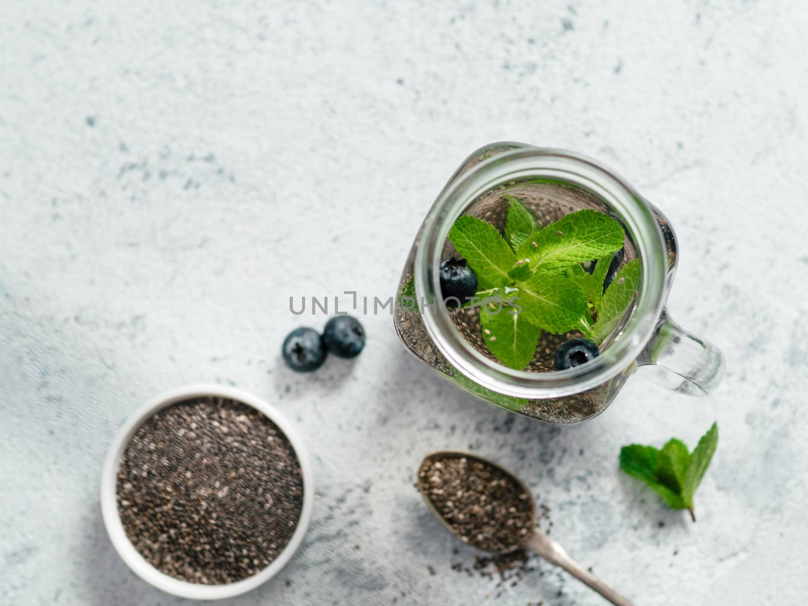 mint and blueberry chia water in mason jar by fascinadora