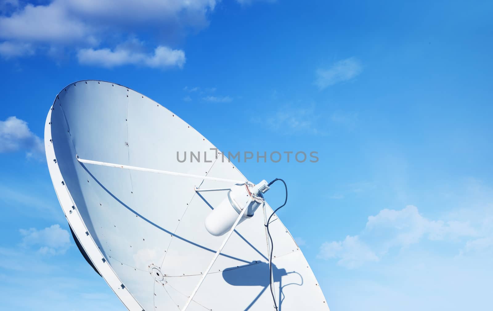 White big parabolic satellite antenna for telecommunications on a background of blue sky. by SlayCer