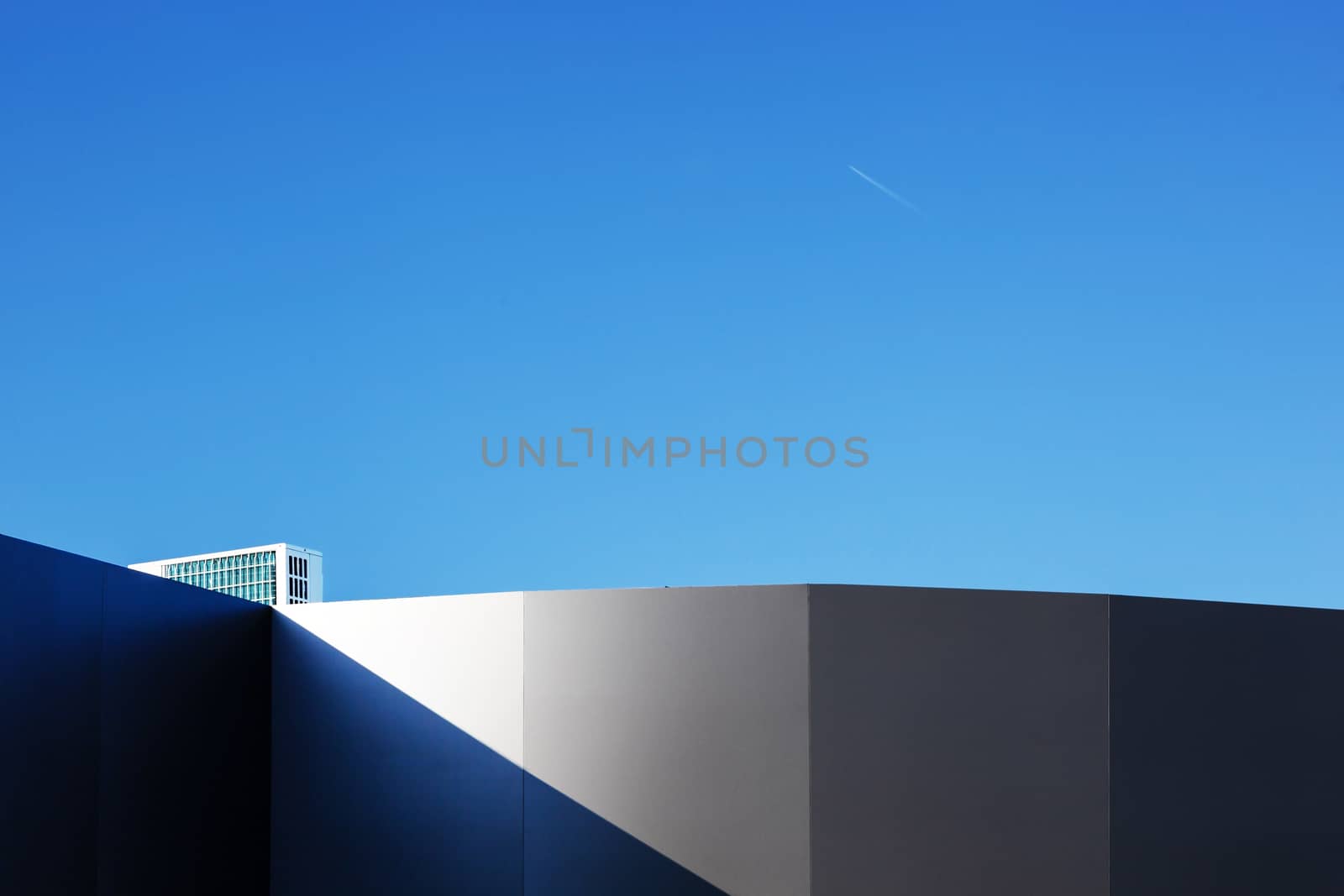 Modern fragment on a construction building, against blue sky by SlayCer