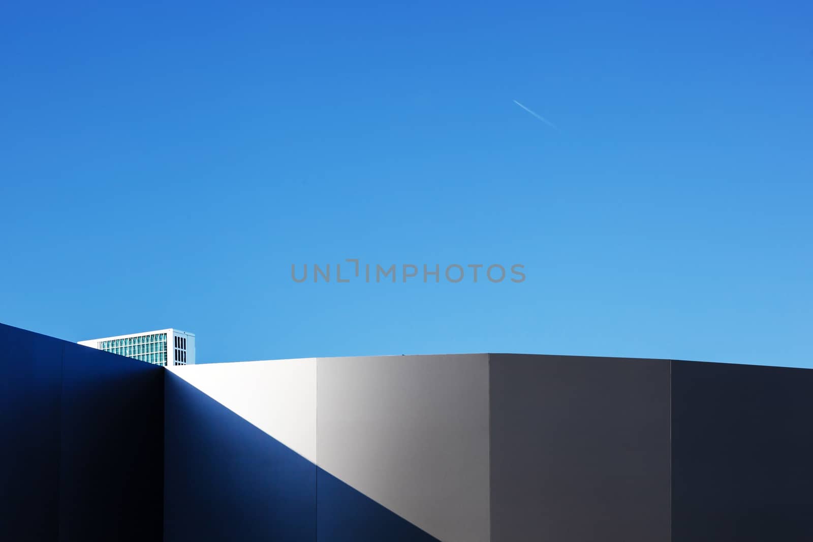 Modern fragment on a construction building, against blue sky, Sunny day