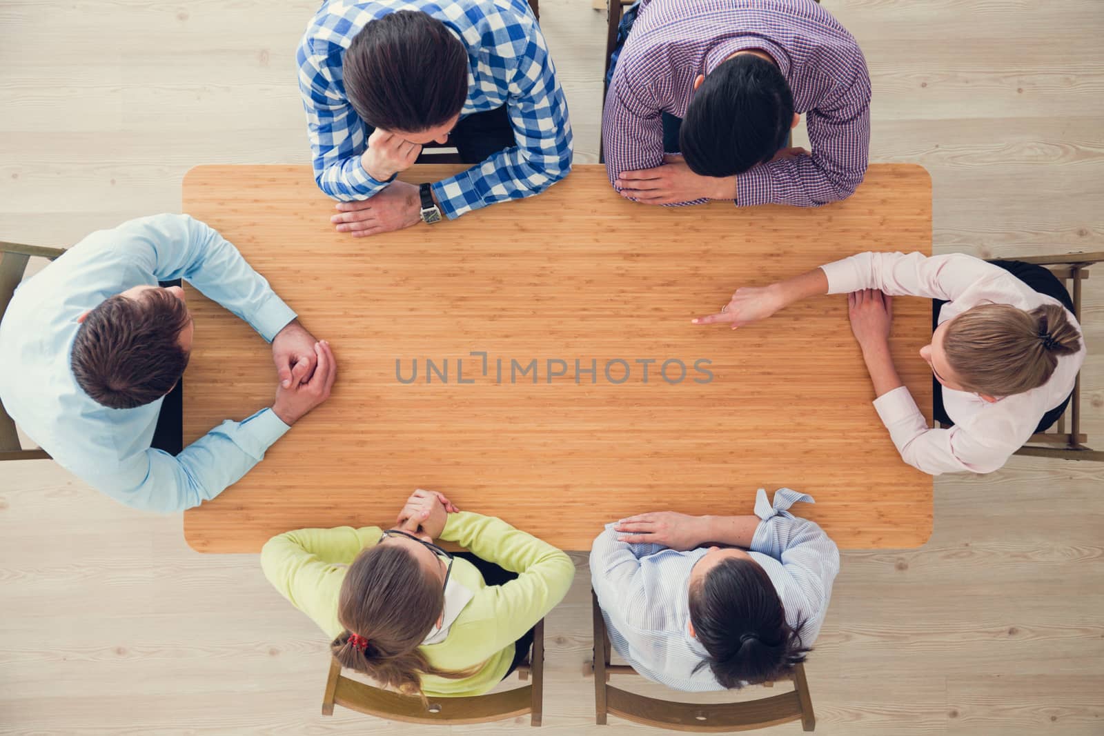 Hipster business teamwork brainstorming planning meeting concept, people team sitting around the table pointing to copy space