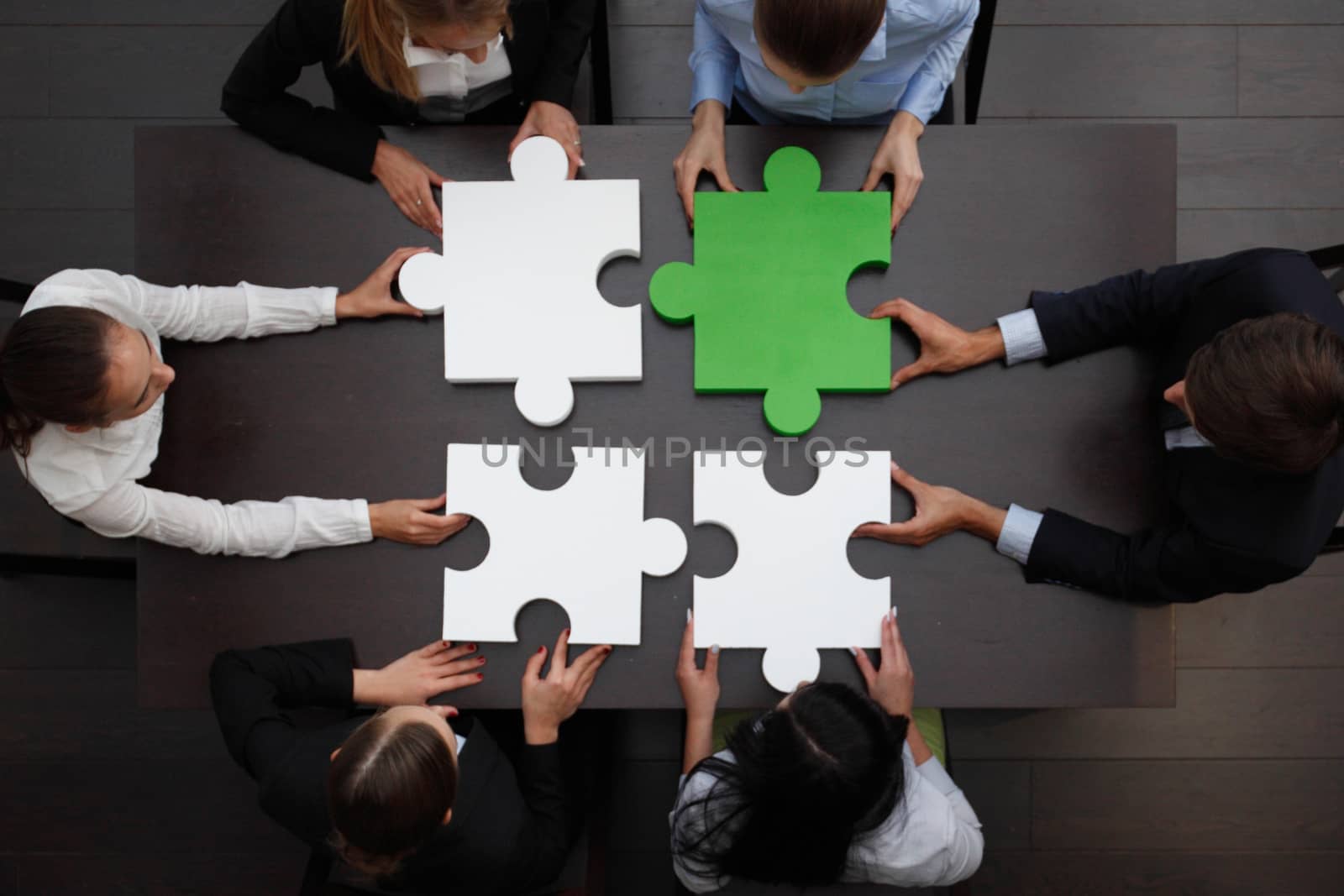 Group of business people assembling jigsaw puzzle, team support and help concept