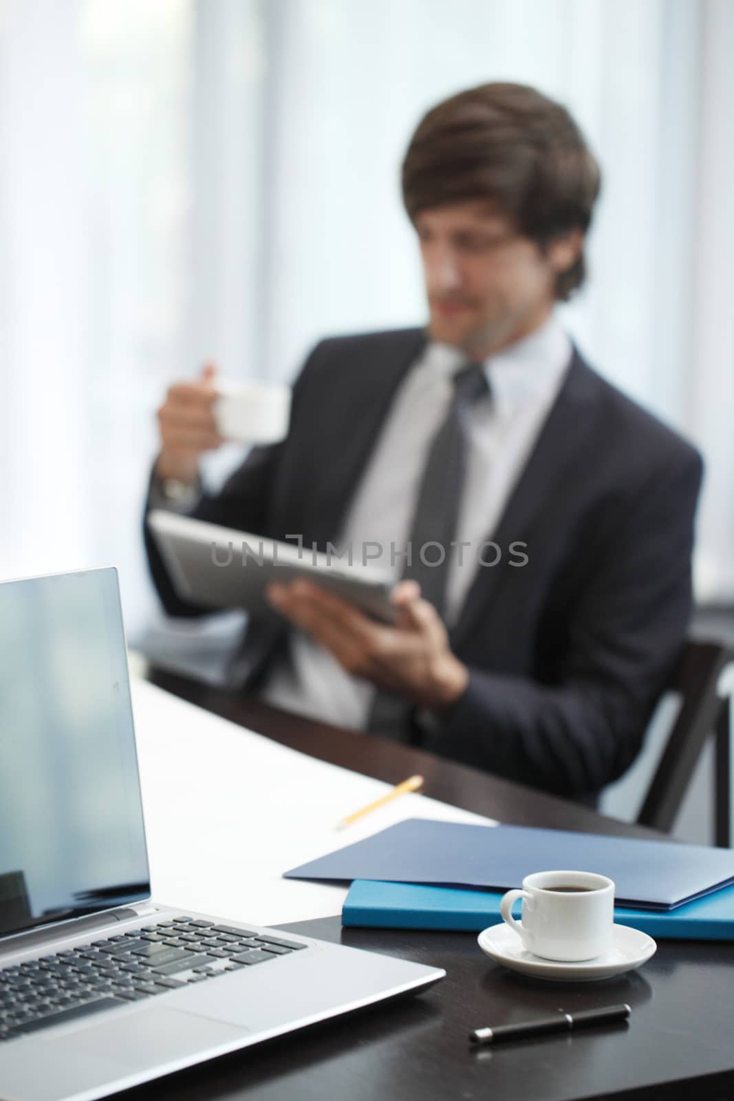 Business man with tablet computer in office