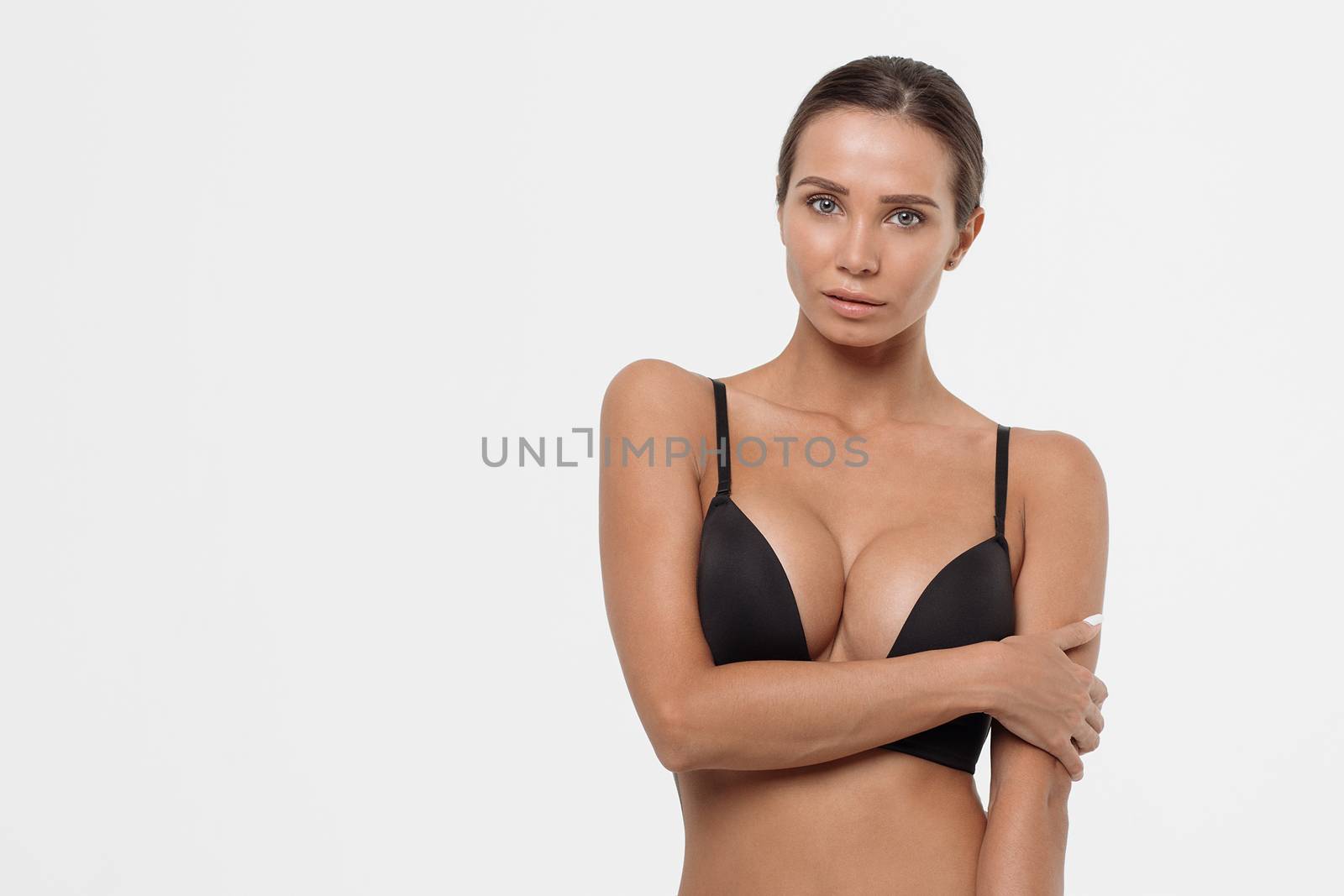 Sexy woman in a black lingerie on the white background