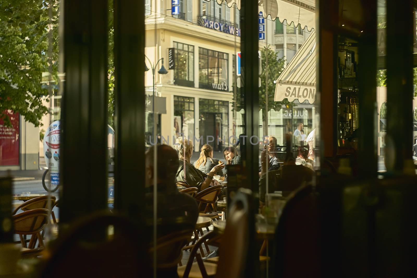 Detail of a daily life scene in the morning of Nice, breakfast in a bar on a central street.