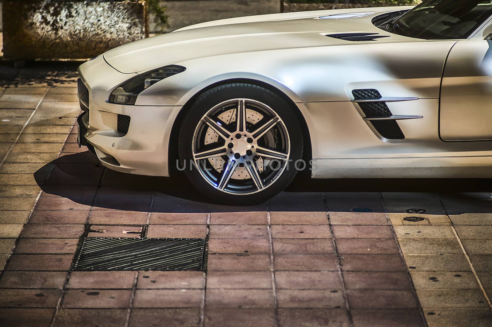 Luxury car parked in a nice street, luxury emblem of some neighborhoods of this city