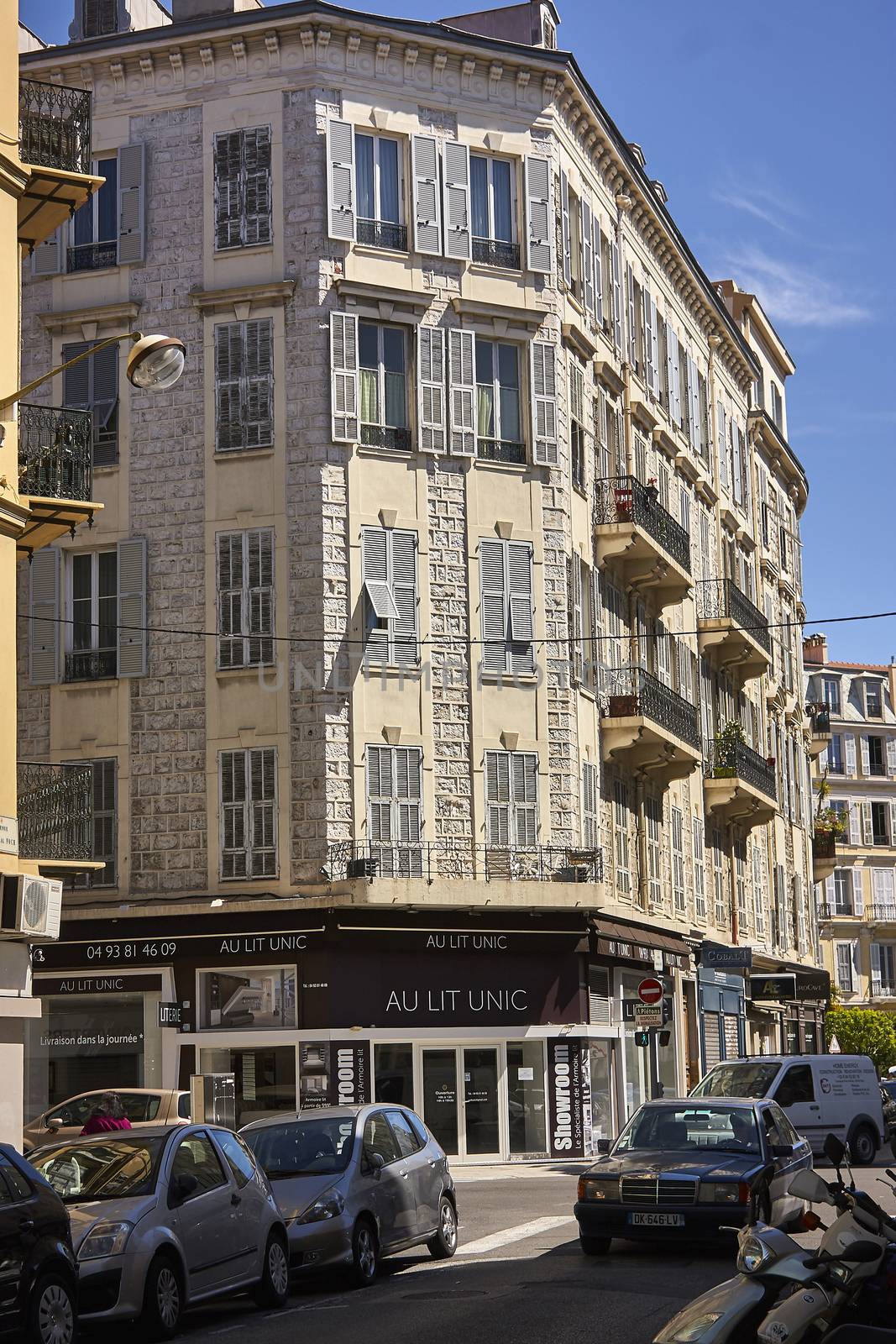 Vertical shot of a nice condominium nestled in a downtown street.