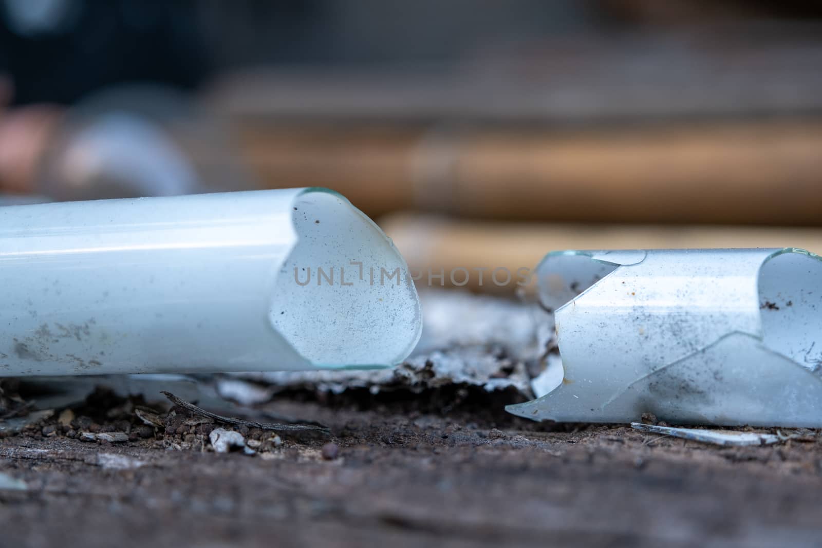 Select focus Pile of broken fluorescent light bulb is danger for health with blur background