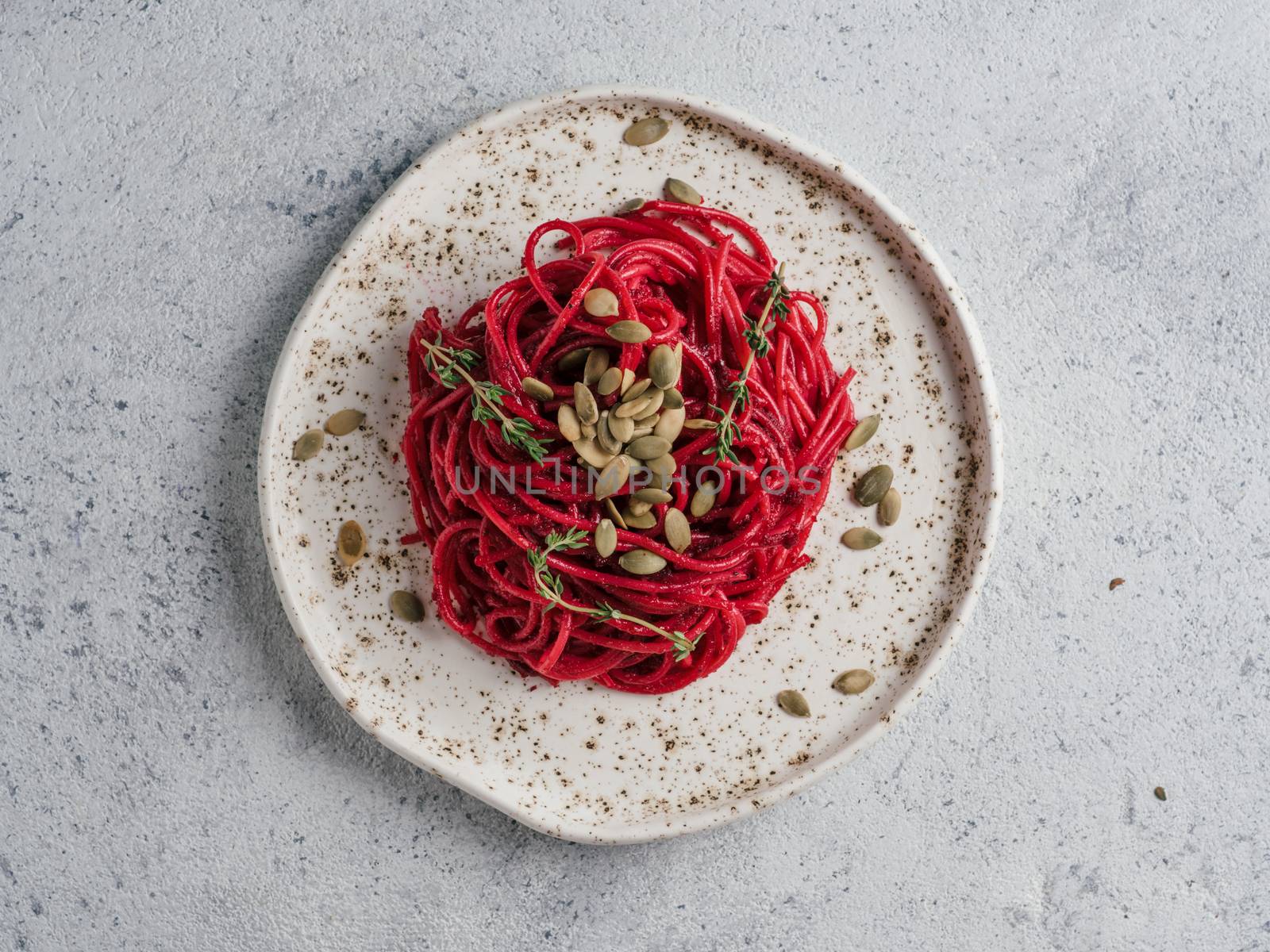 Beetroot pesto or hummus. Homemade beet pesto sauce in glass jar and fresh thyme on dark black background. Copy space for text. Ideas and recipes for healthy vegetarian detox diet food