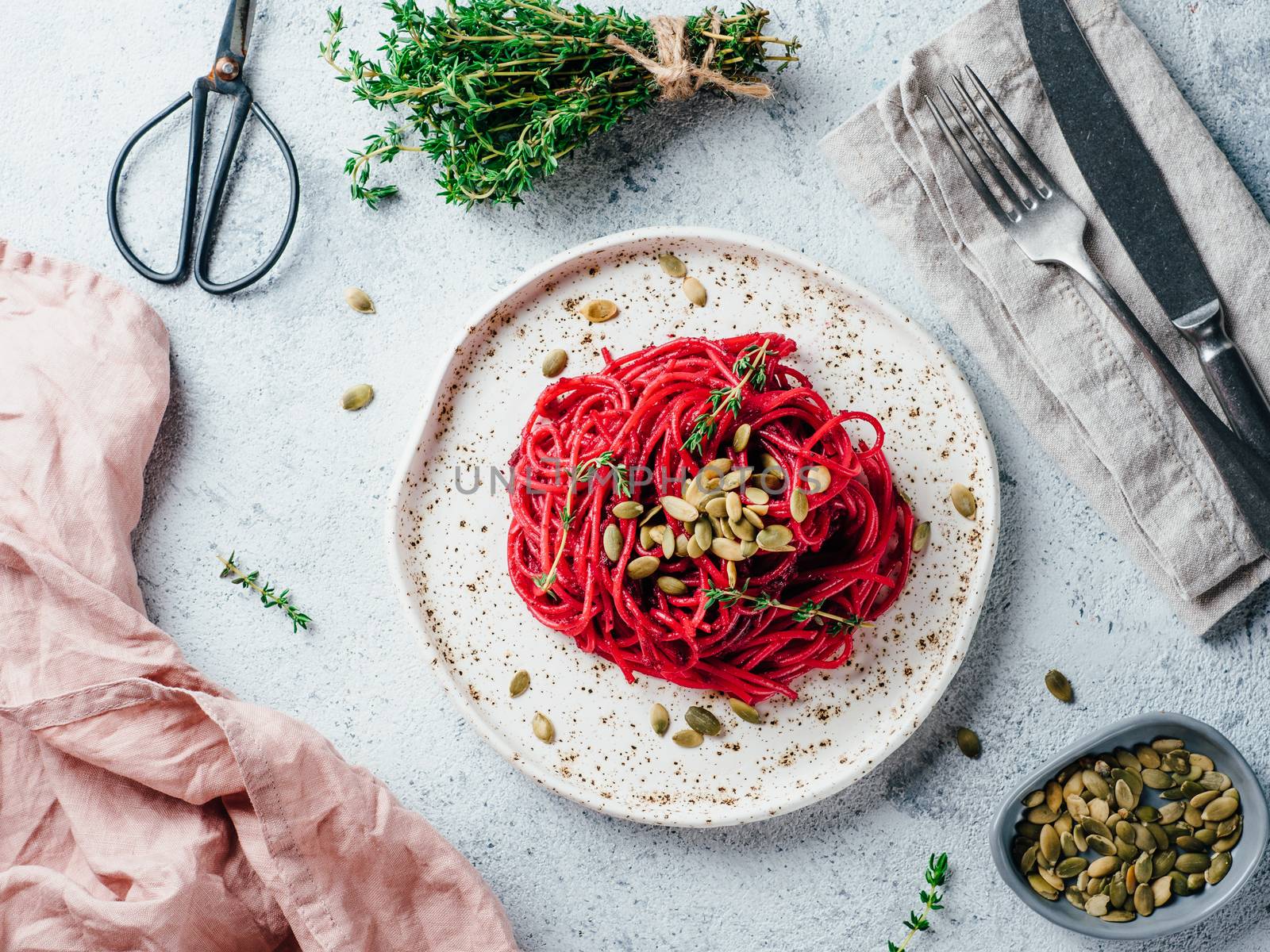 Beetroot pesto or hummus. Homemade beet pesto sauce in glass jar and fresh thyme on dark black background. Copy space for text. Ideas and recipes for healthy vegetarian detox diet food