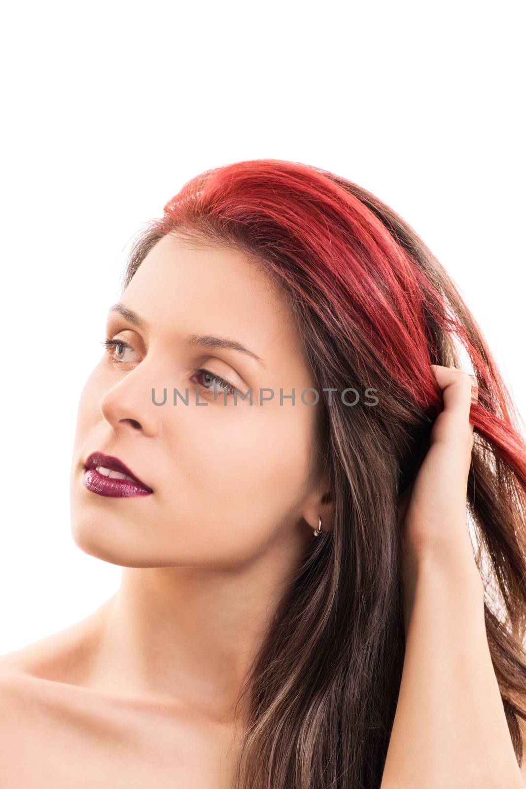 Sensual portrait of a beautiful young woman with soft clean make up, going through her hair with her hand, isolated on white background.