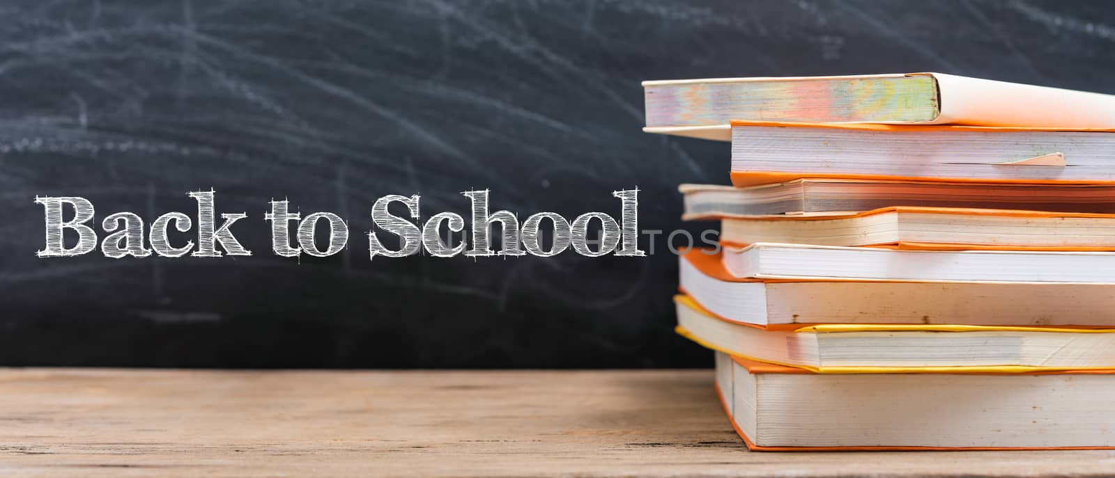 Classroom, with stack books on table have blackboard by Sorapop