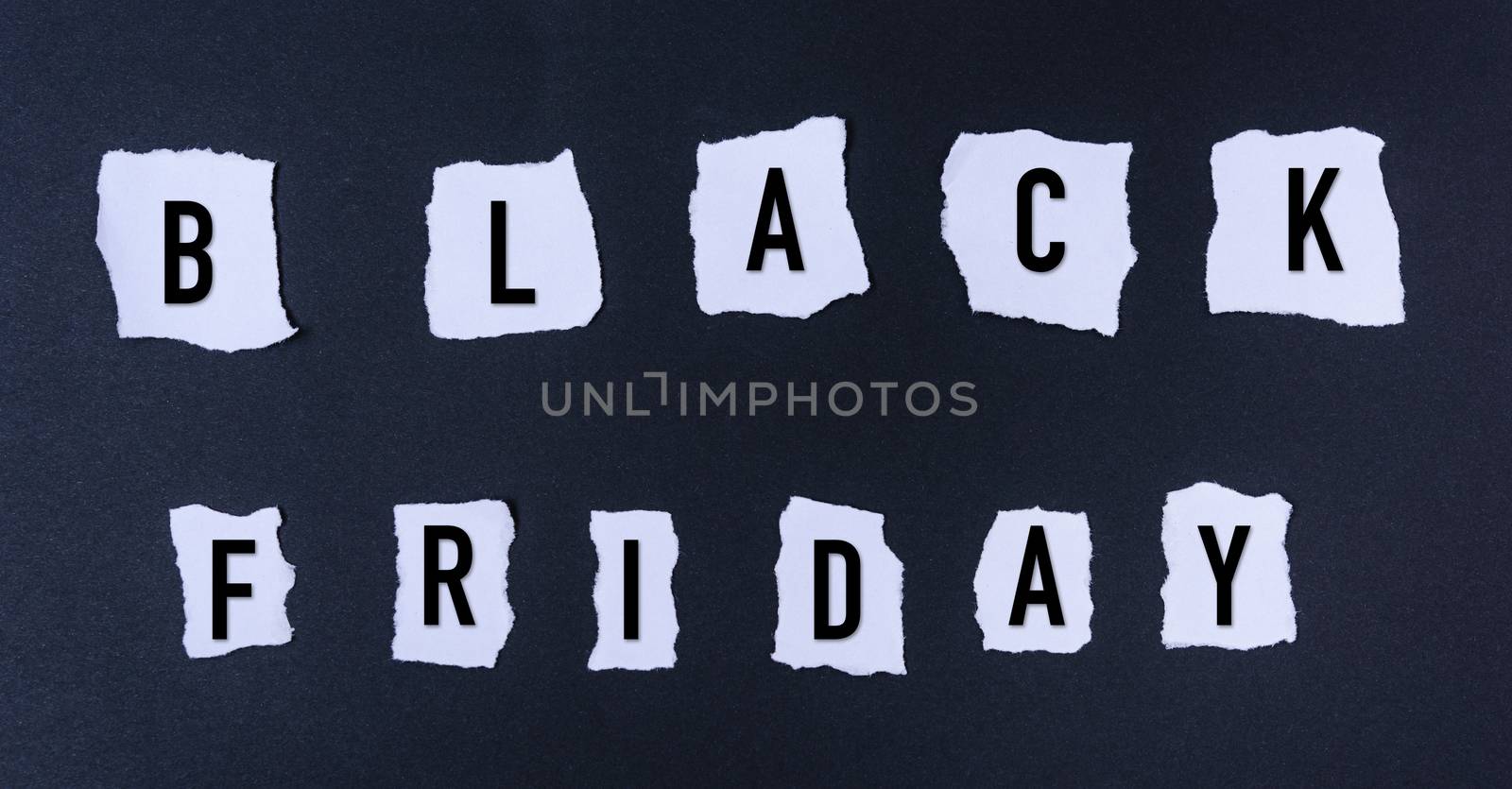 Black Friday words text into white paper torn by Sorapop