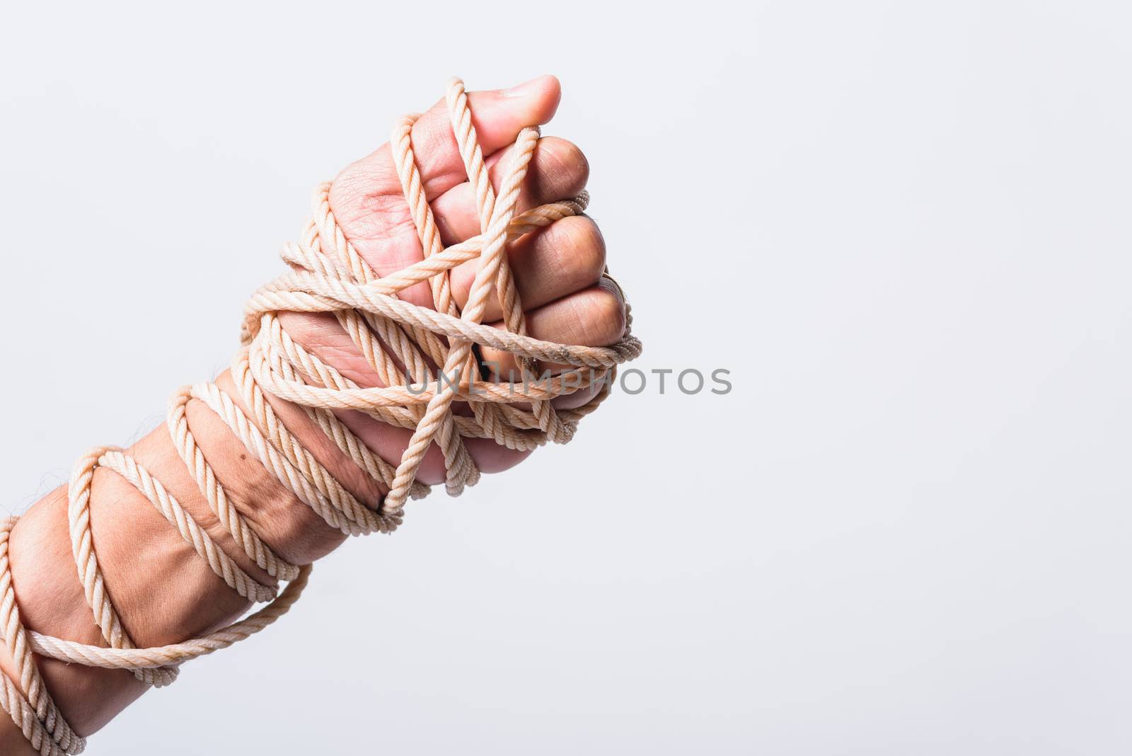 Rope on fist hand on white background, Human rights day concept with copy space for use