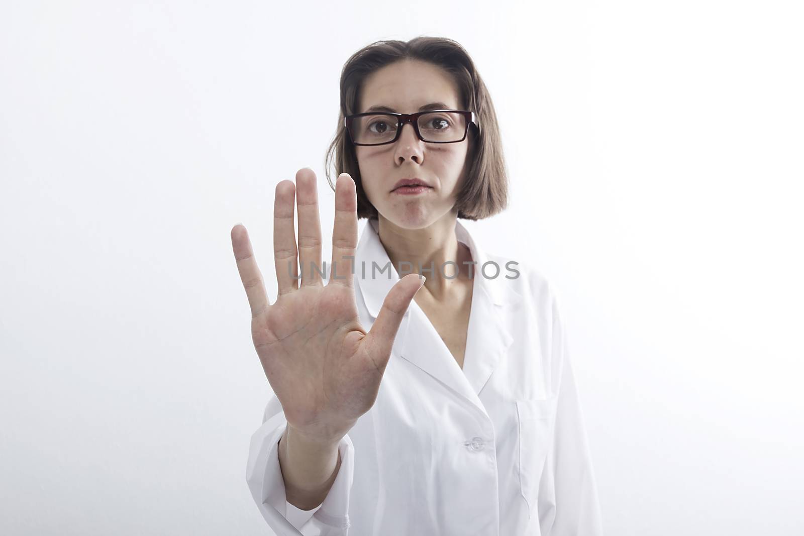 Doctor woman with raised open palm on white background