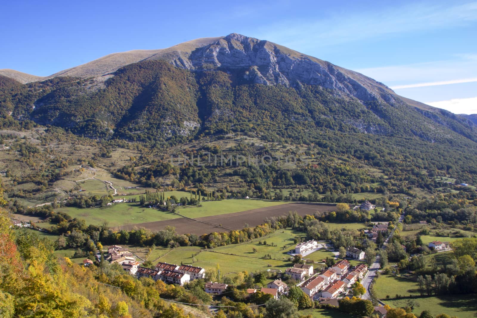 landscape of a sunny valley and mountain peaks as seen from the town of Opi, in Abruzzo national park, Italy