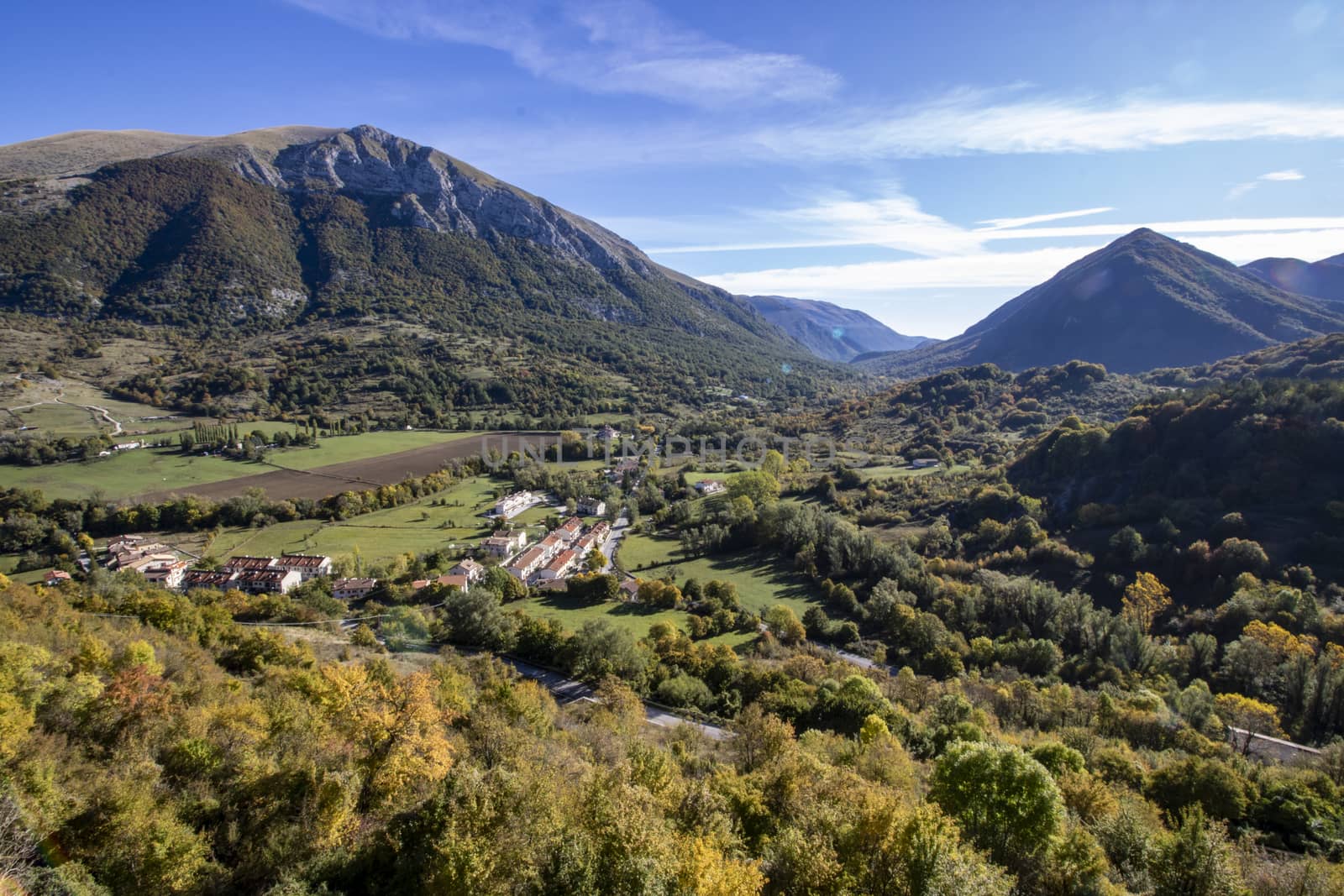 landscape of a sunny valley and mountain peaks as seen from the town of Opi, in Abruzzo national park, Italy