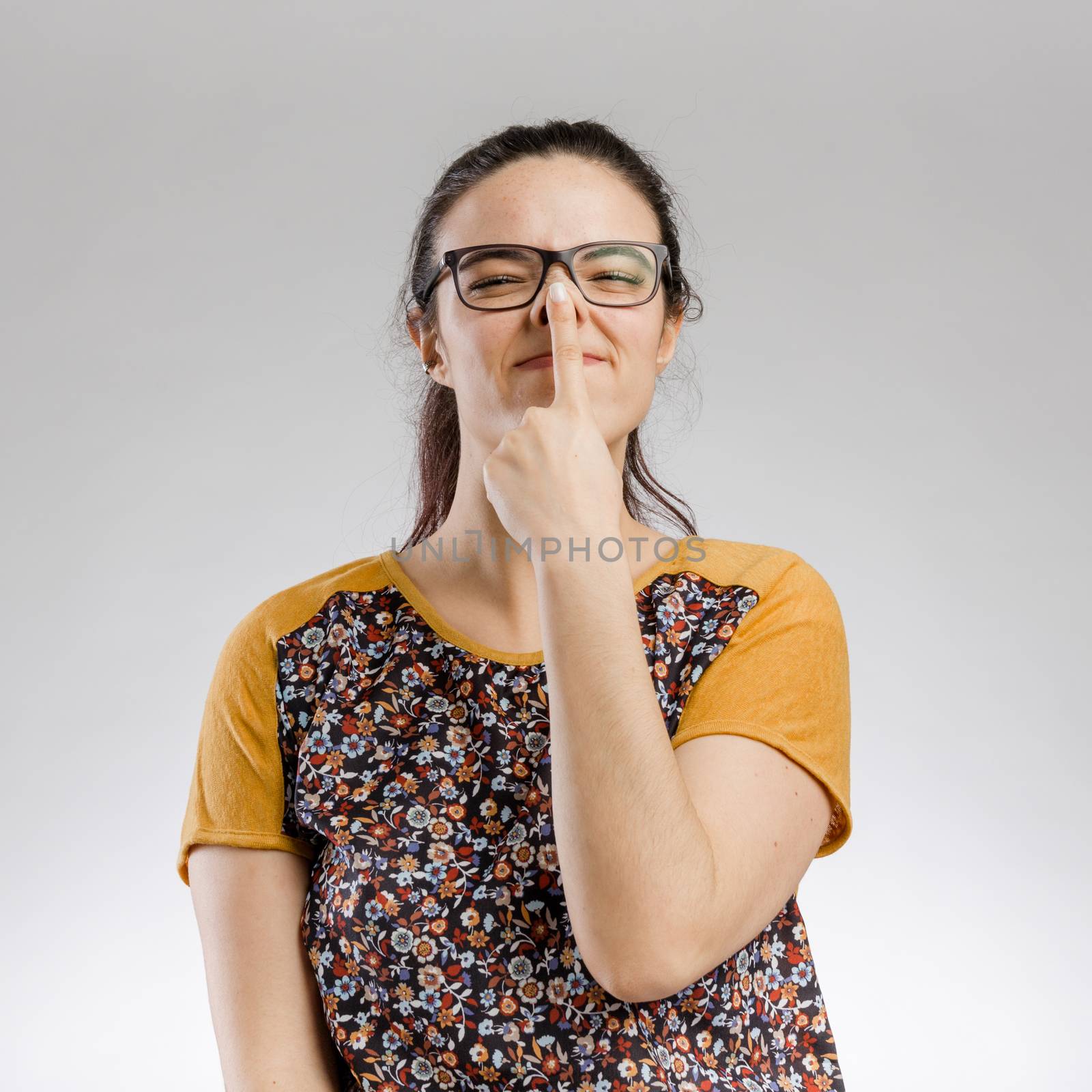 Cute portrait of a woman touching her nose