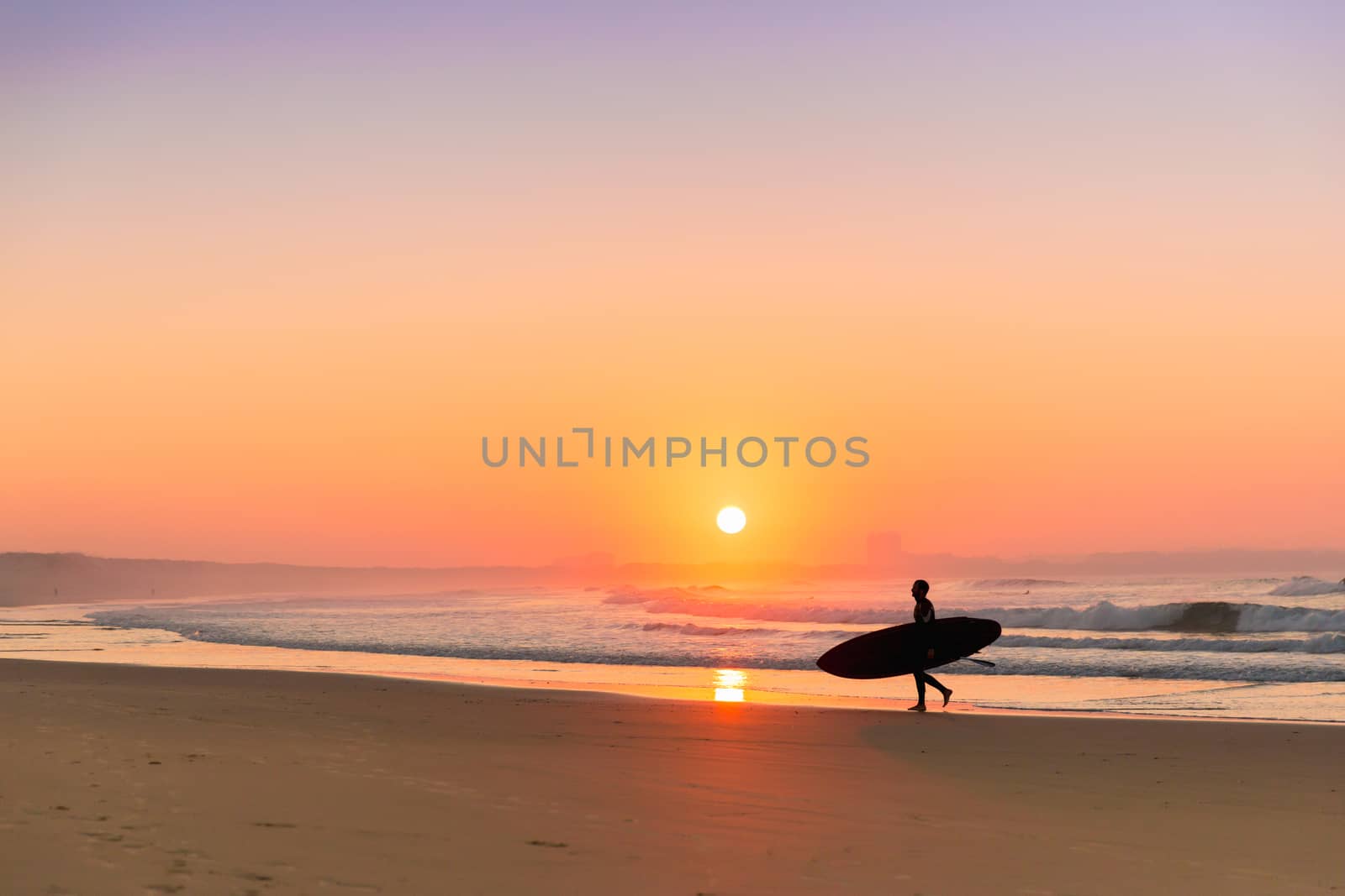 Surfer leaving the ocean after a long day of surf(