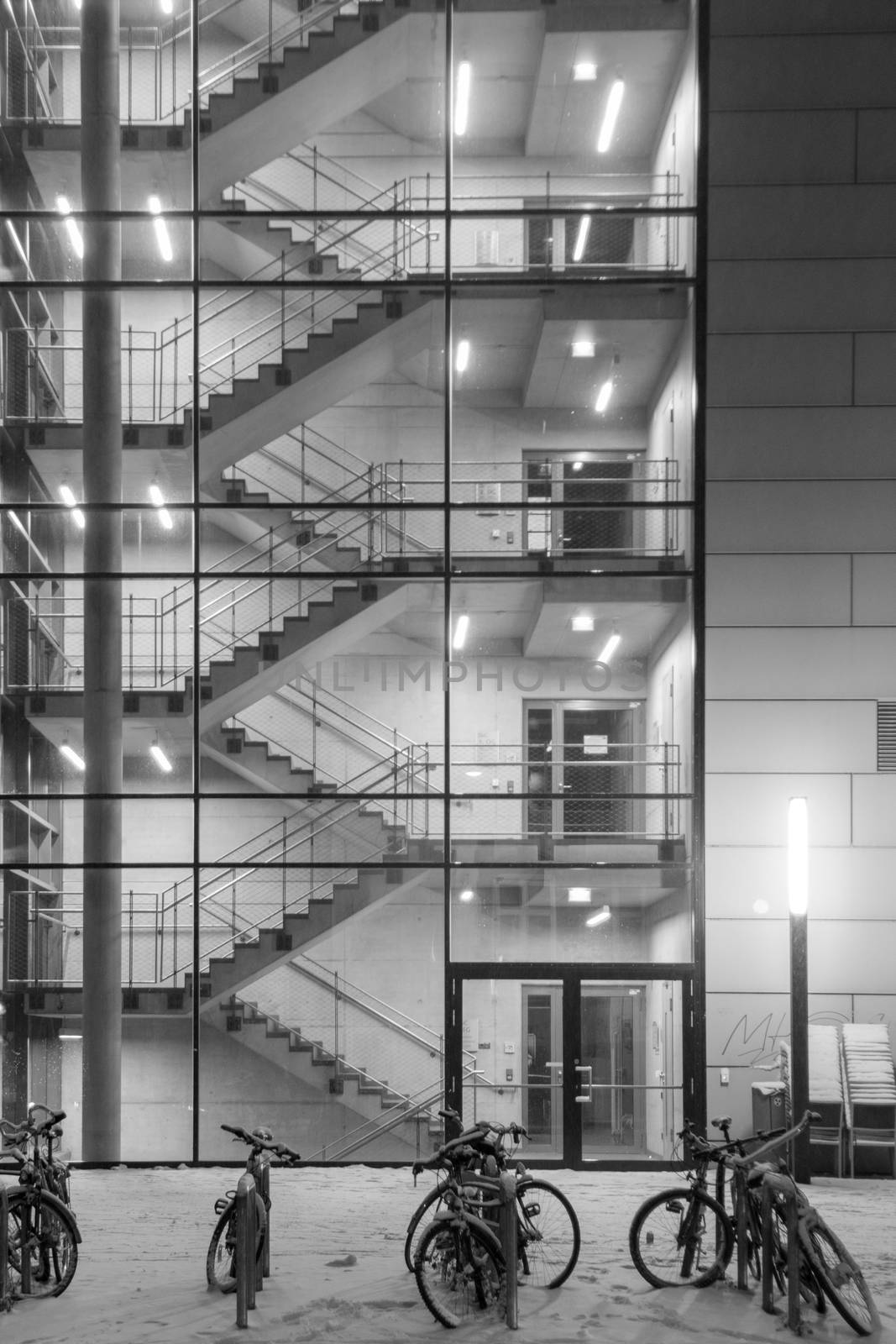 Stairwells behind the transparent glass of the building in winter. Background image.
