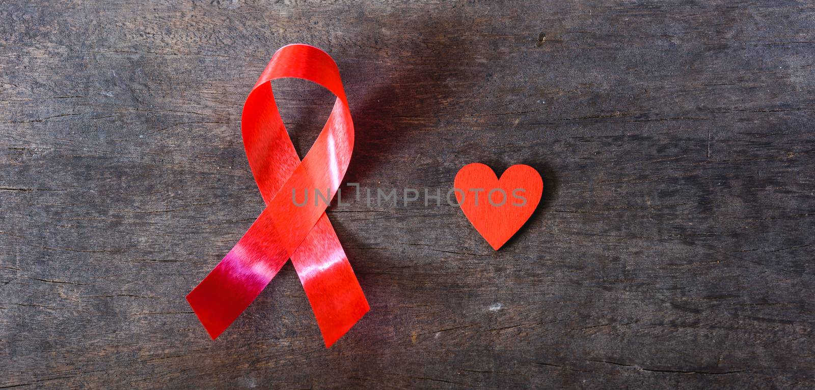 Red Ribbon Support HIV, AIDS and red Heart by Sorapop