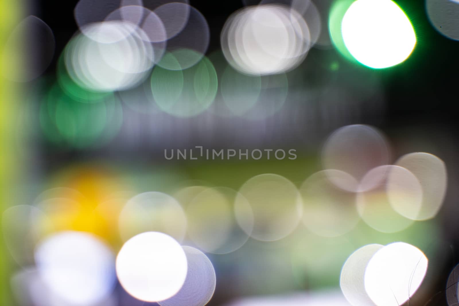 Abstract circular bokeh background of light in dining room. This image is burred or selective focus. by peerapixs