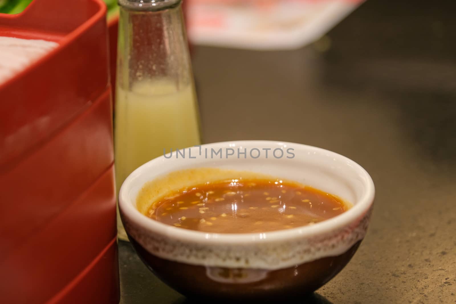 close up sesame and soy sauce with a glass of minced chili and garlic by peerapixs