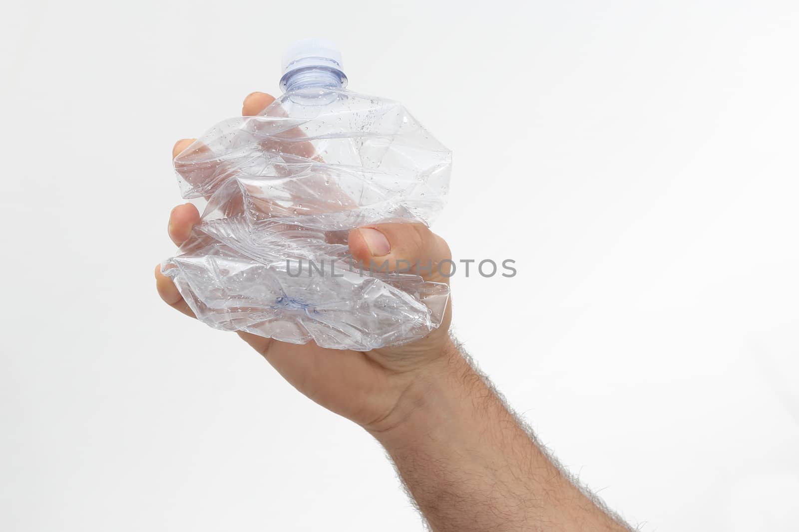 conceptual plastic free photo - the plastic bottle held in the hand