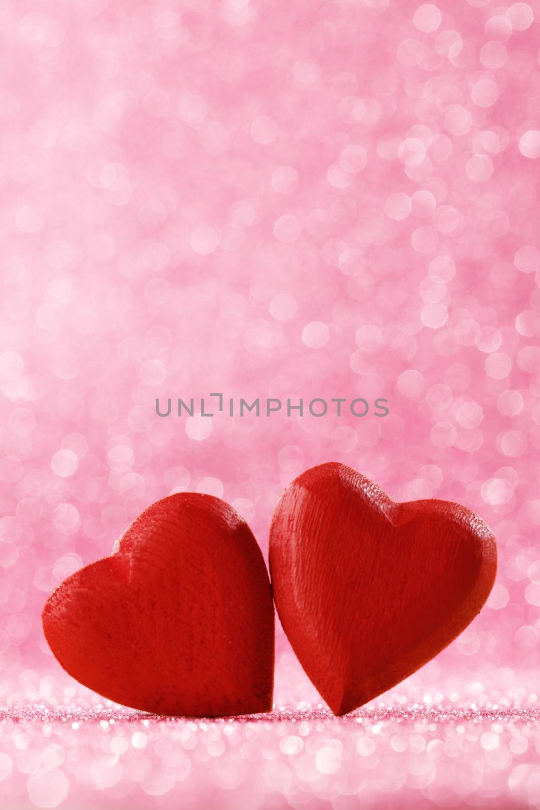 Two red hearts on bokeh background by Yellowj