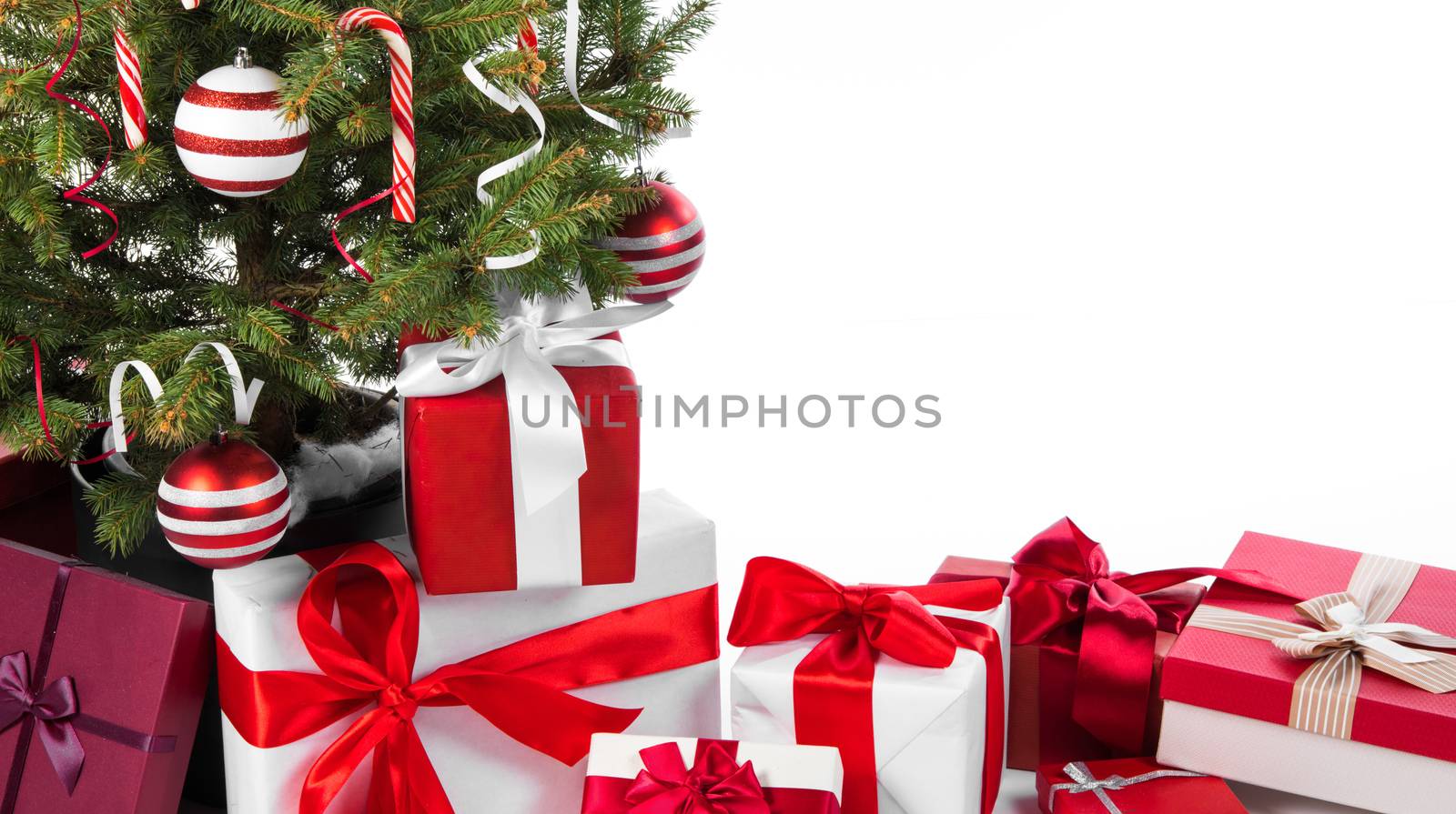Decorated Christmas tree and gift boxes isolated on white background