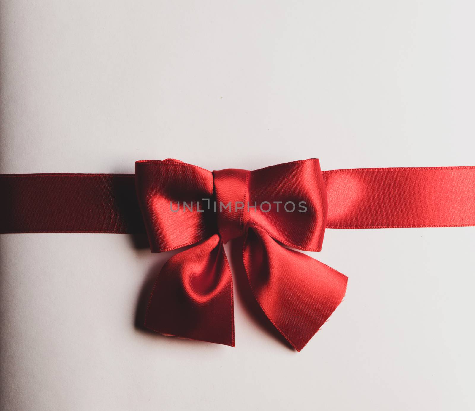 Red gift bow on white background holiday gift concept