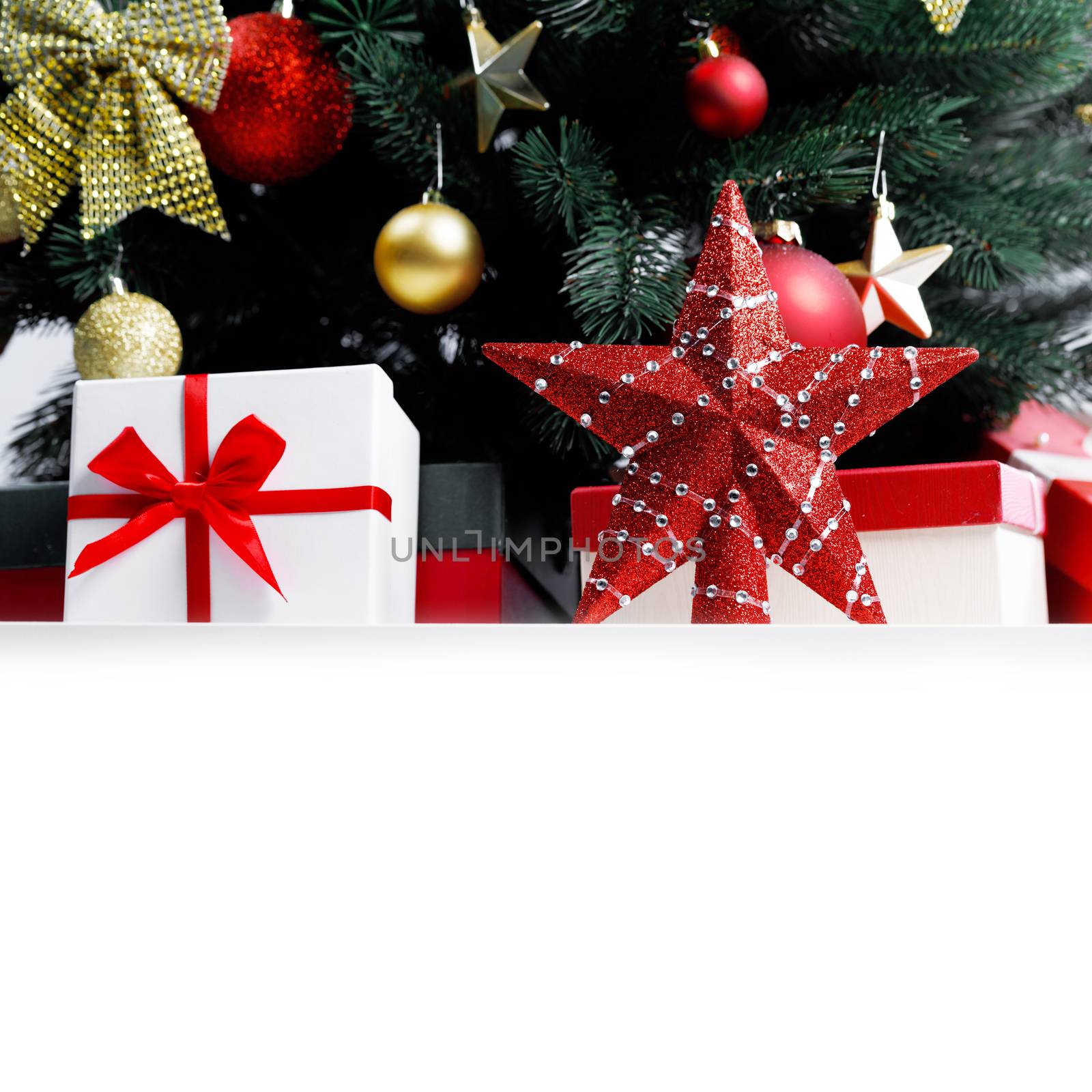 Decorated Christmas gifts and star under tree with baubles isolated on white background