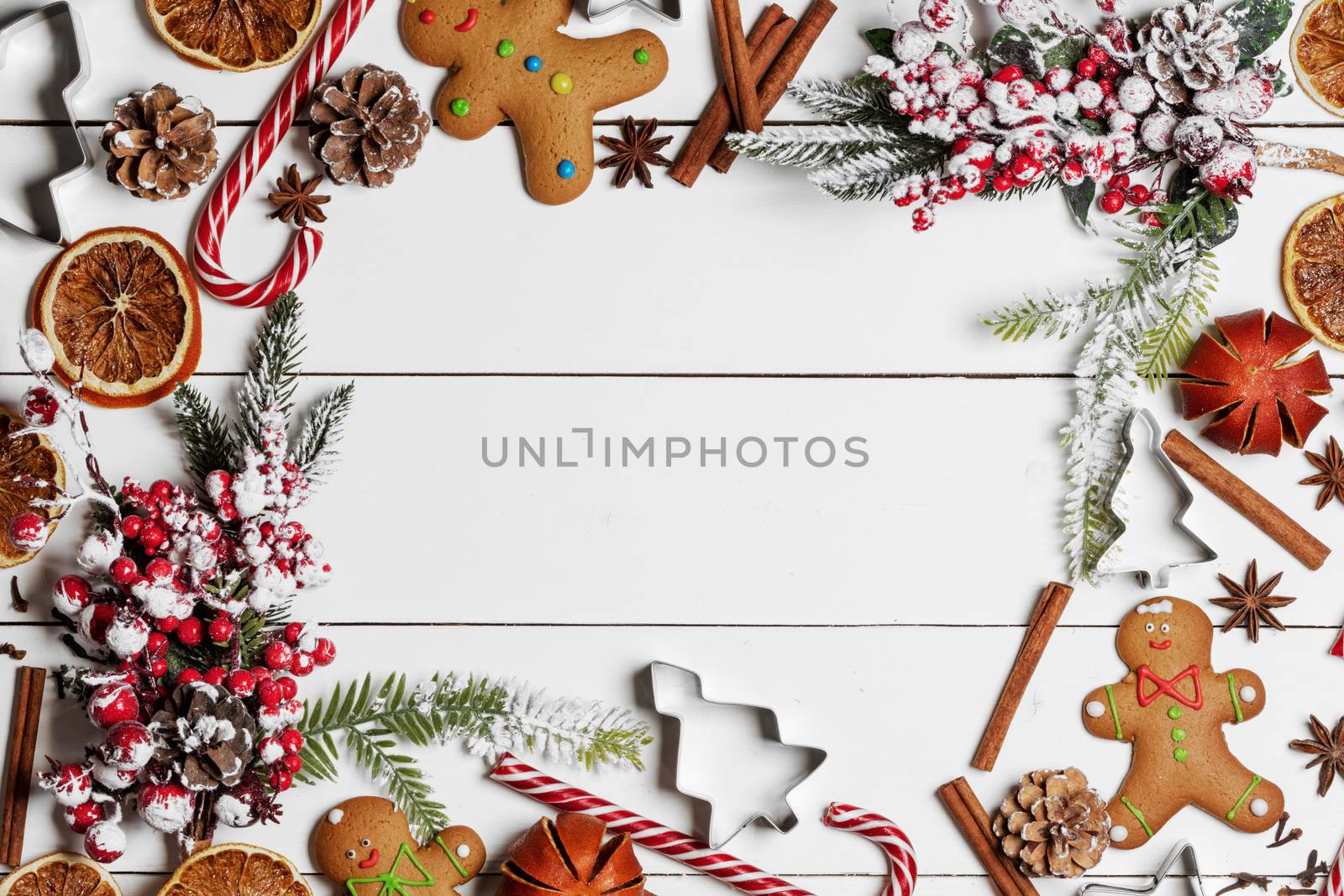 Christmas food frame. Gingerbread cookies, spices and decorations on white table background with copy space