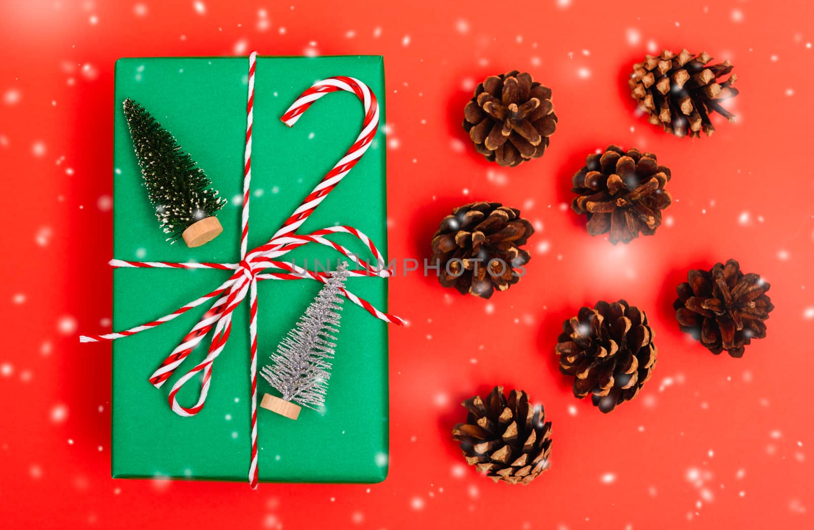 New Year, Christmas Xmas holiday composition, Top view gift green box, clews of rope and green fir tree branch on red background with copy space