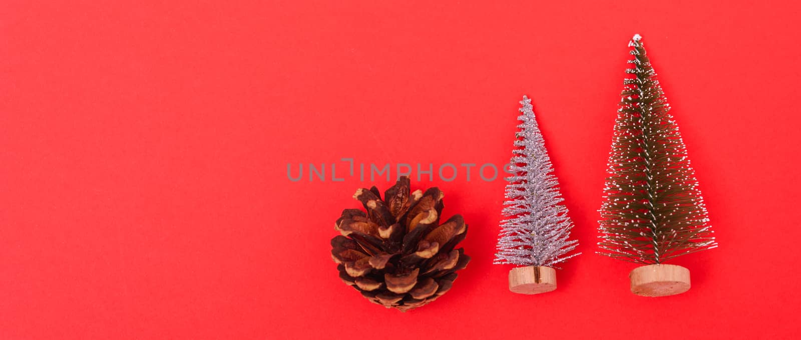 New Year, Christmas Xmas holiday composition, Top view green fir tree branch on red background with copy space
