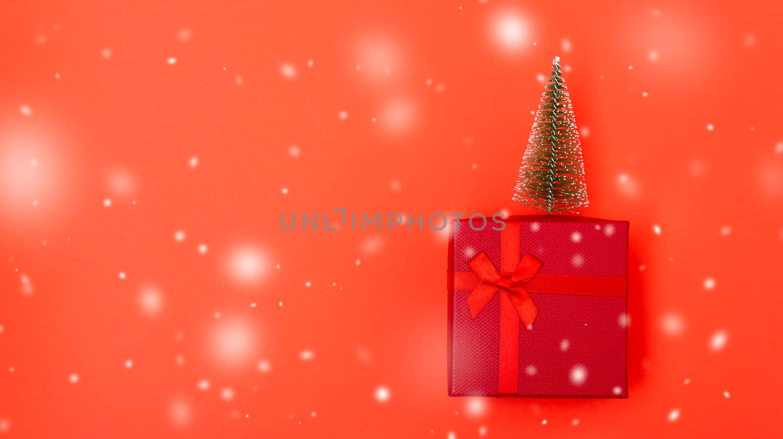 New Year, Christmas Xmas holiday composition, Top view red gift box with green fir tree branch over box on red background with copy space