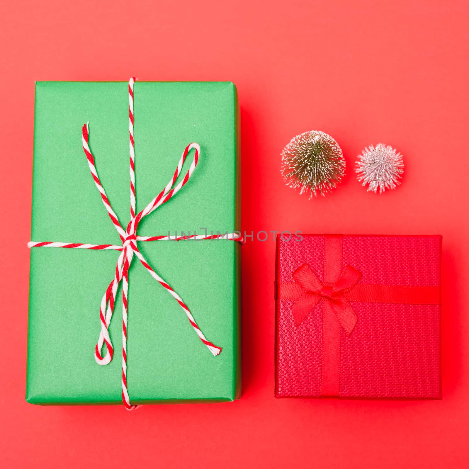 New Year, Christmas Xmas holiday composition, Top view green and red gift box and green fir tree branch on red background