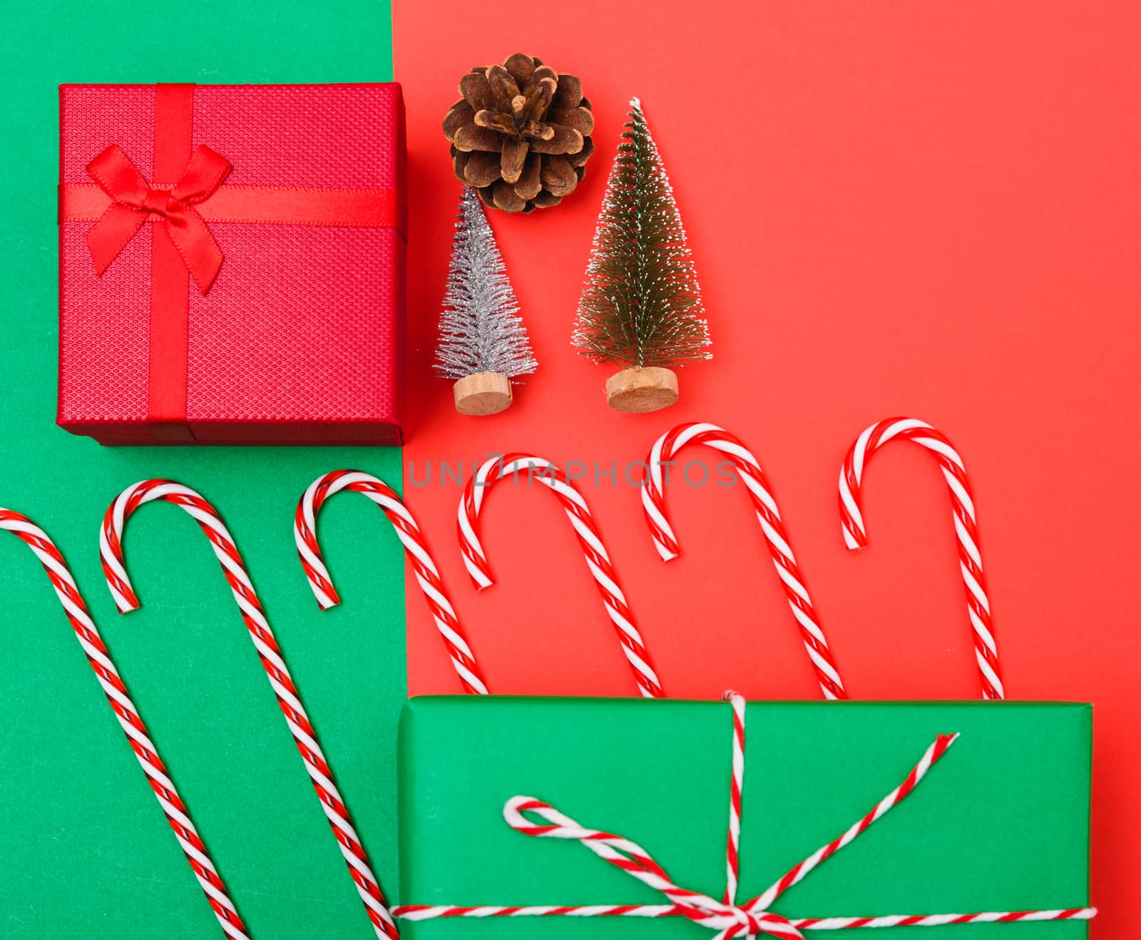 New Year, Christmas Xmas holiday composition, Top view with gift box, clews of rope, green fir tree branch on red and green background with copy space