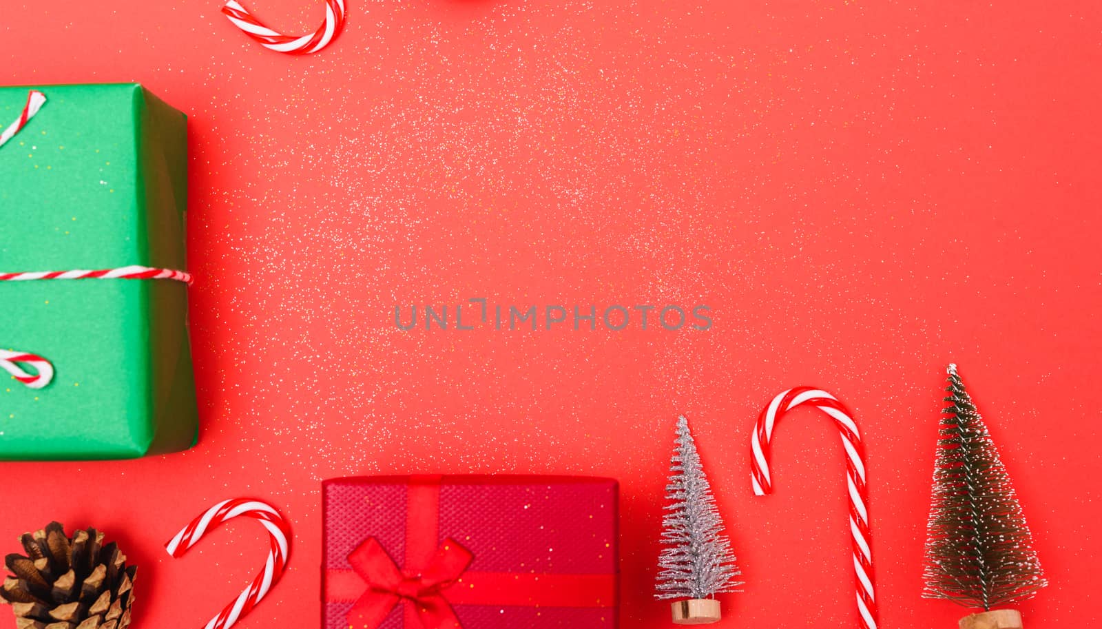 New Year, Christmas Xmas holiday composition, Top view green and red gift box, clews of rope, green fir tree branch on red background with copy space
