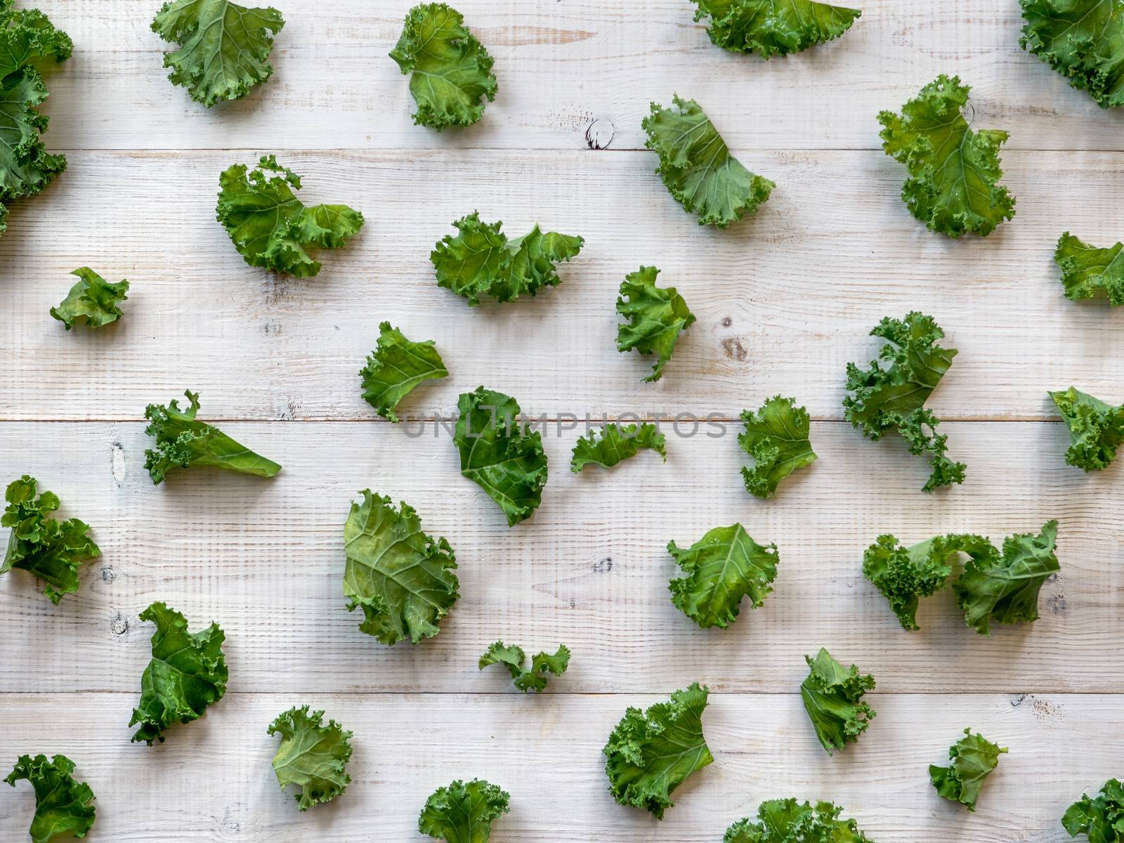 Kale leaves pattern, white wooden table, flat lay by fascinadora