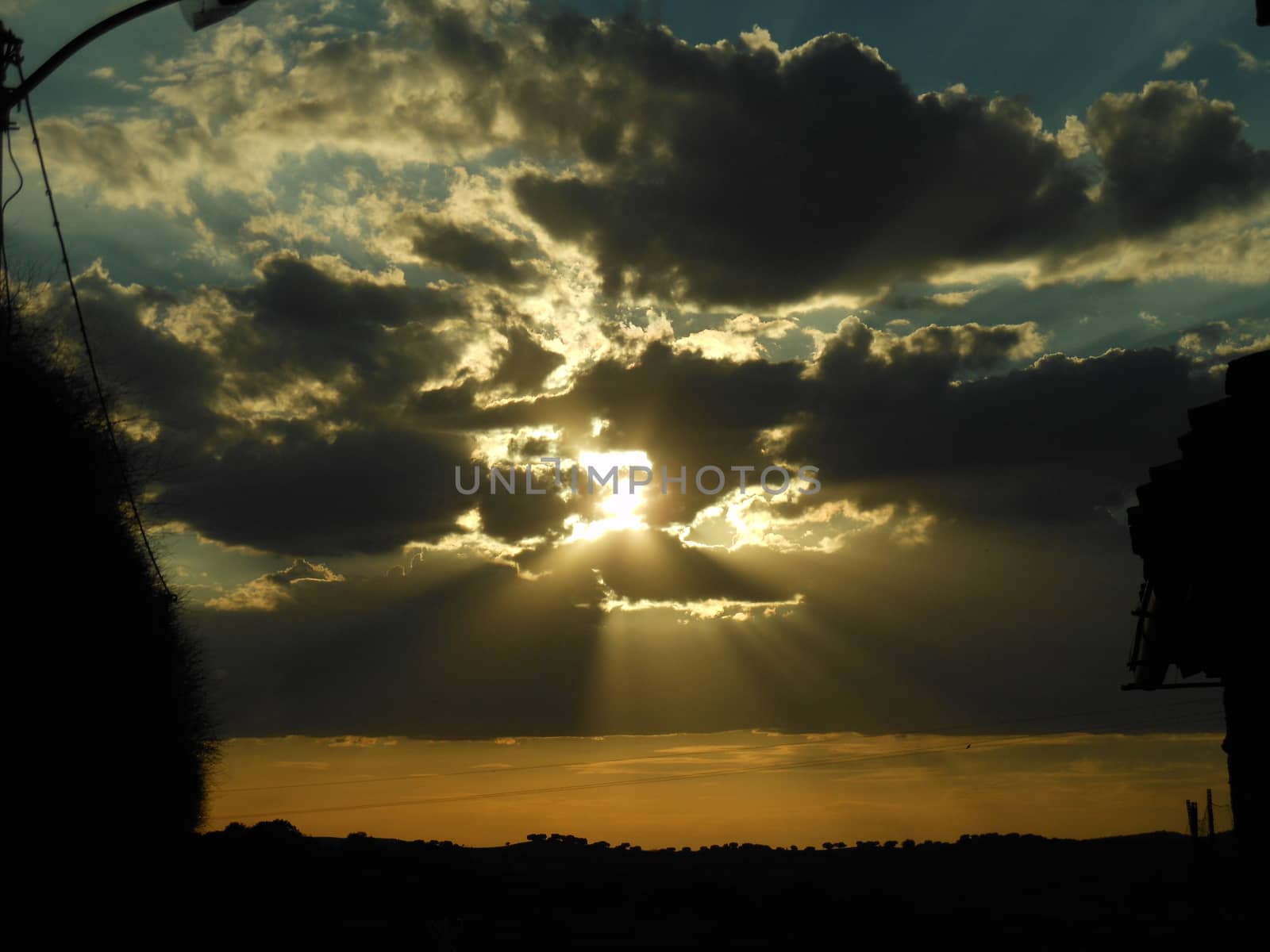 Wonderful sunset among the clouds on a summer afternoon in a village in Spain