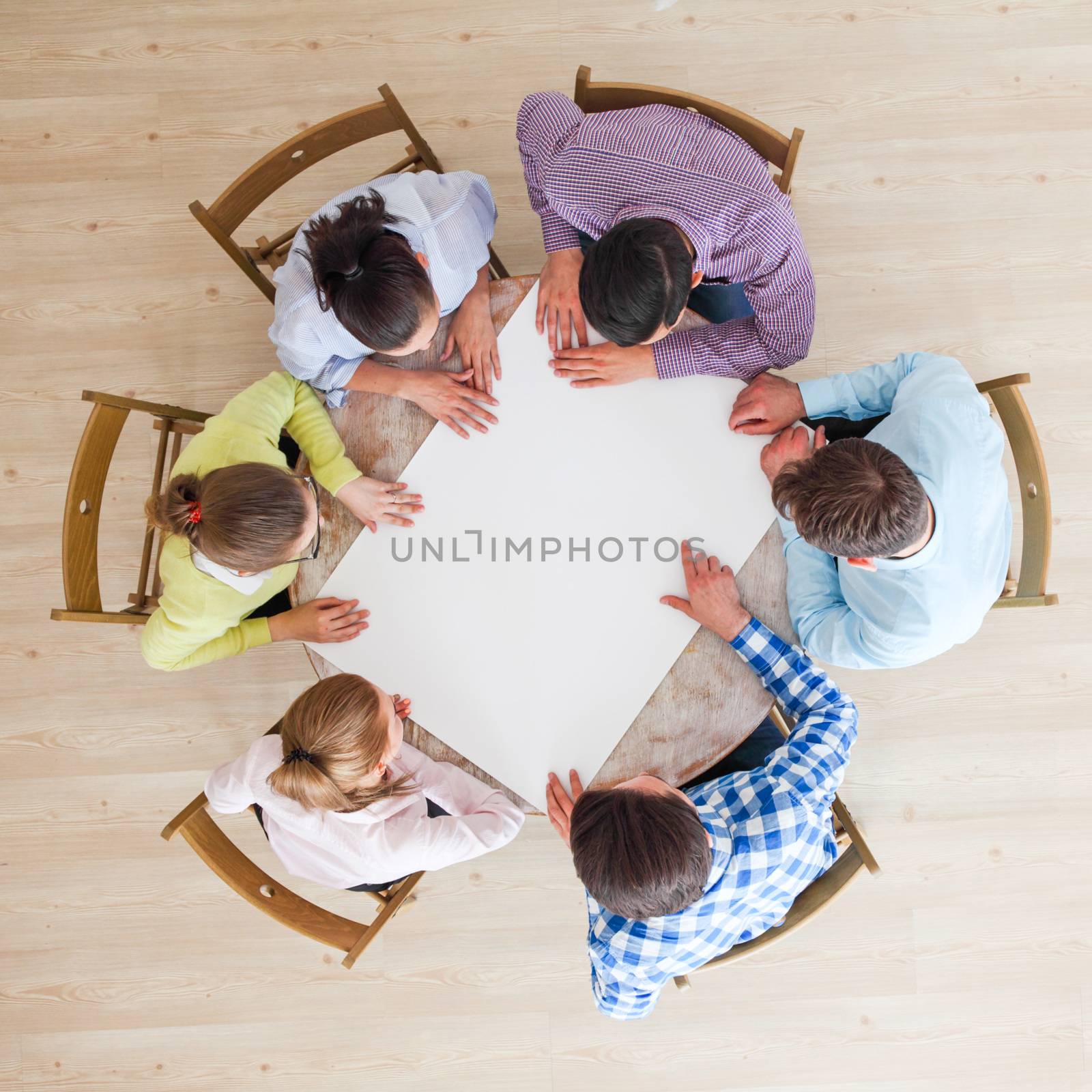 Hipster business teamwork brainstorming planning meeting concept, people team sitting around the table with white paper and pointing, copy space