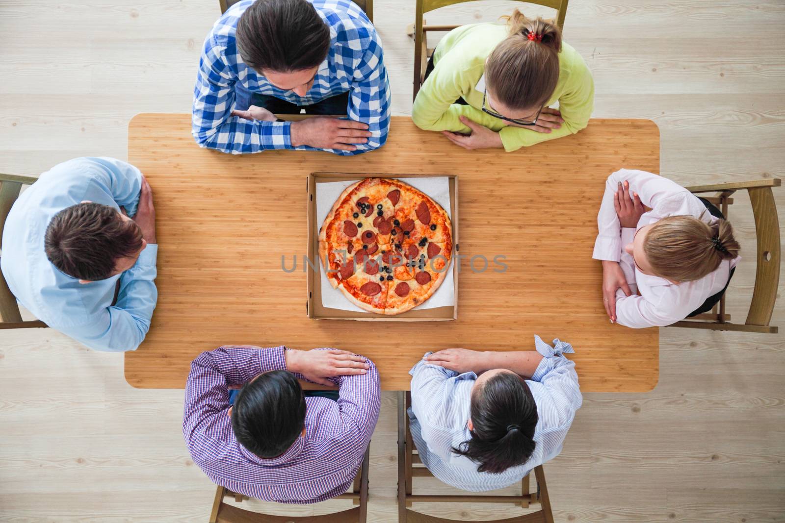People hands grabbing pizza from delivery box, top view
