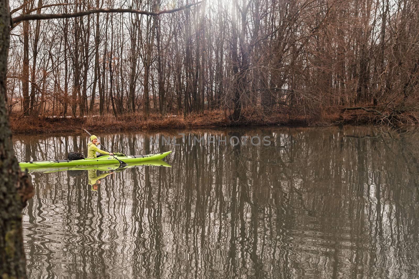 The girl floats on the river in a kayak.A girl on a kayak.