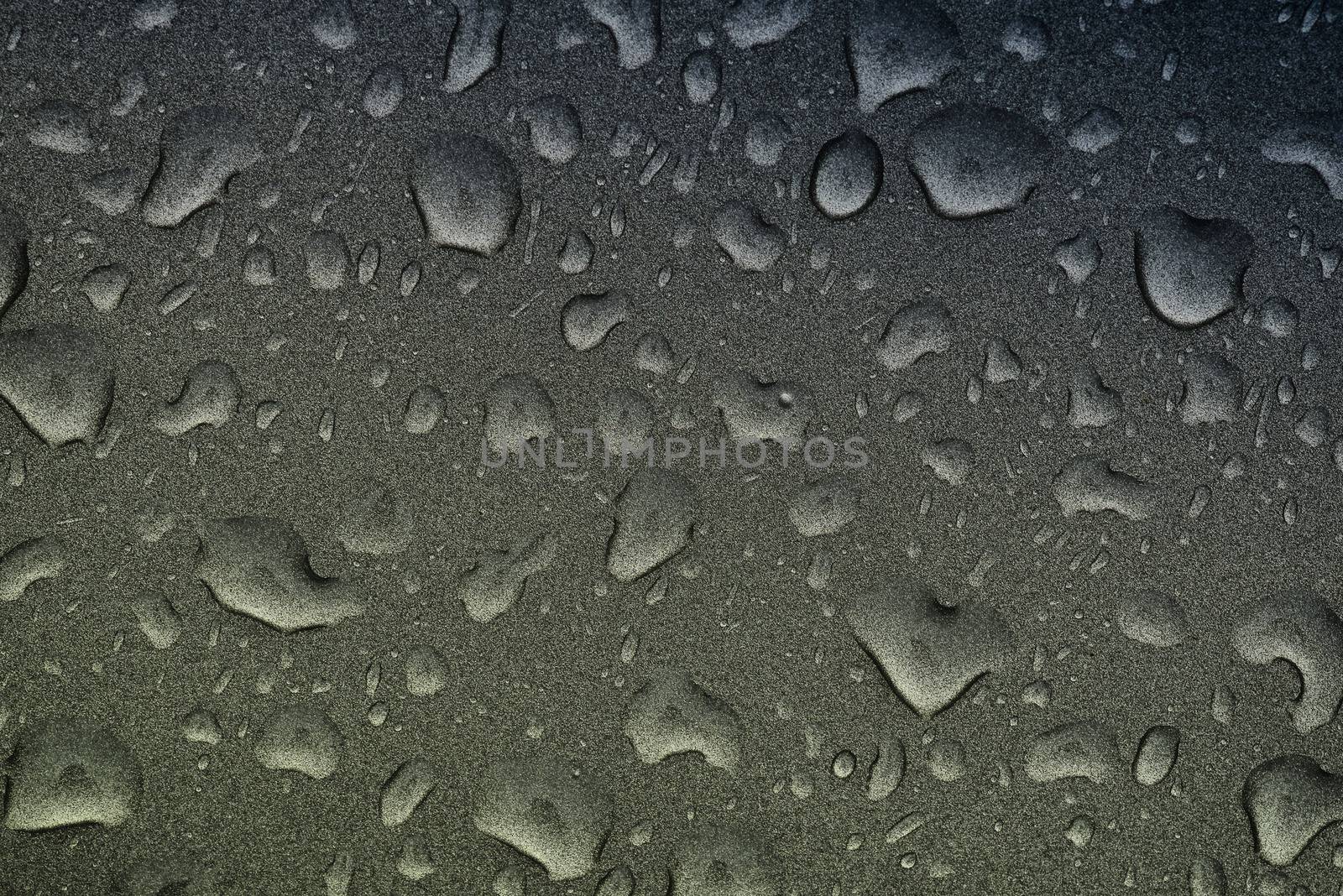 Fresh raw chicken fillet on a wooden cutting board.Water droplets on black background.