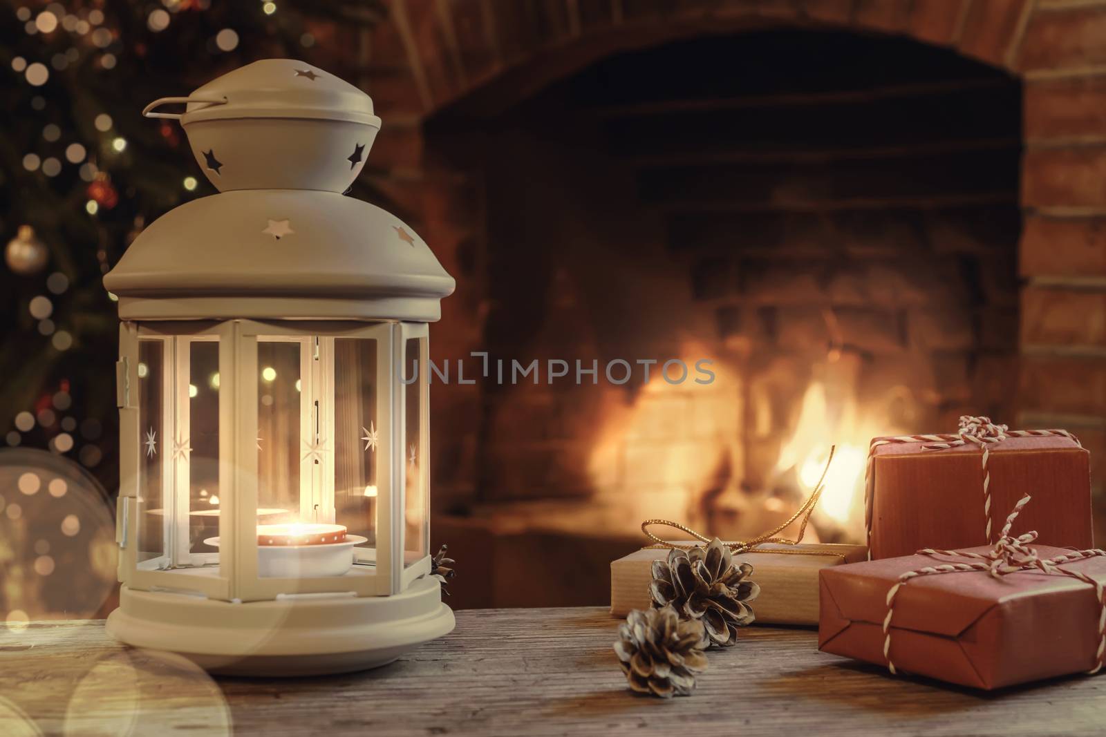 Lantern with a burning candle, gifts on a wooden table in a room with a Christmas tree and a fireplace on Christmas Eve.