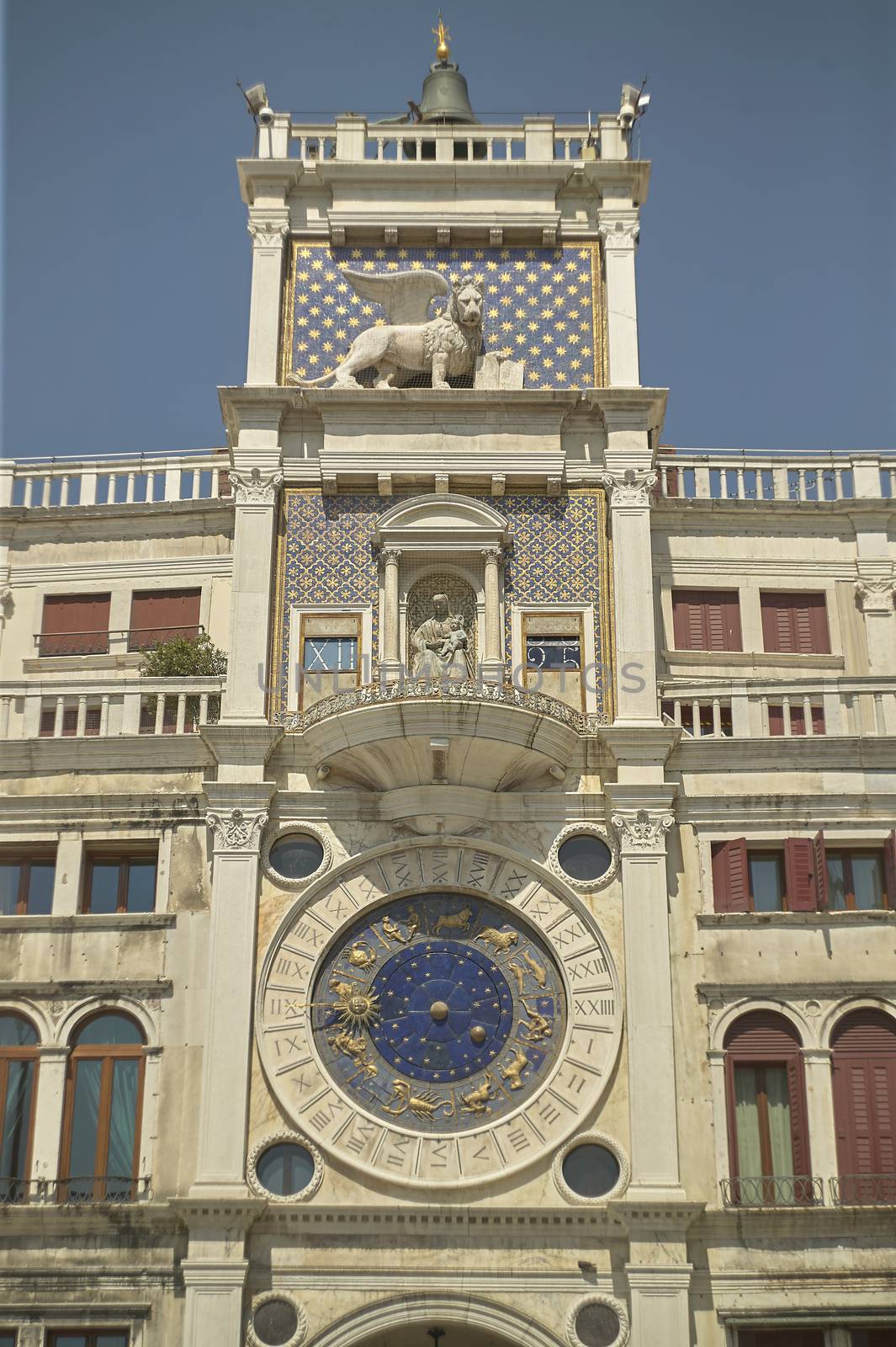From the bottom of the clock tower in Piazza San Marco in Venice, with its distinctive clock visible.