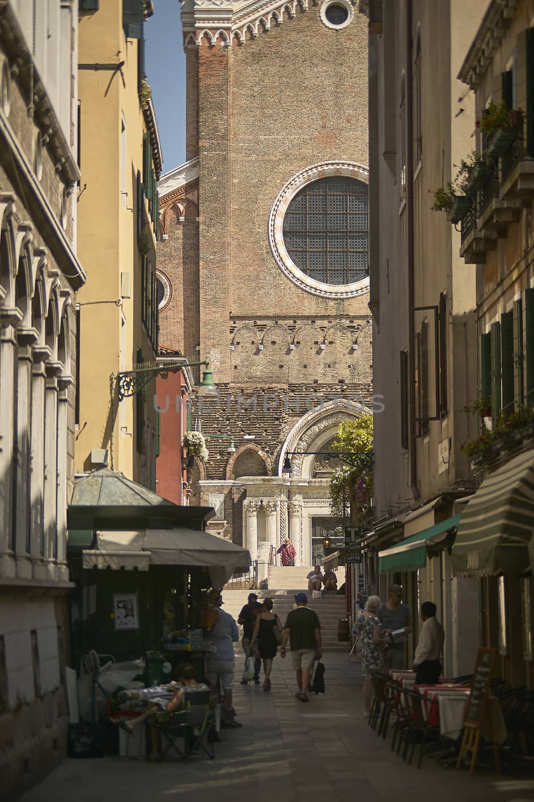 Small street in Venice with a church at the bottom of it